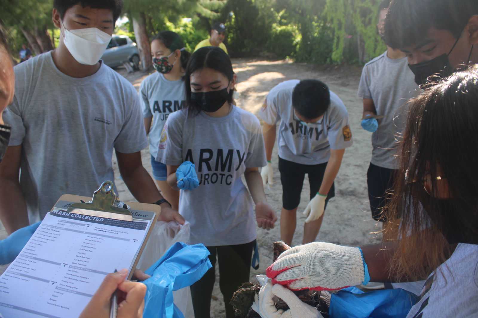 A leader tallies the litter collected by the cadets.