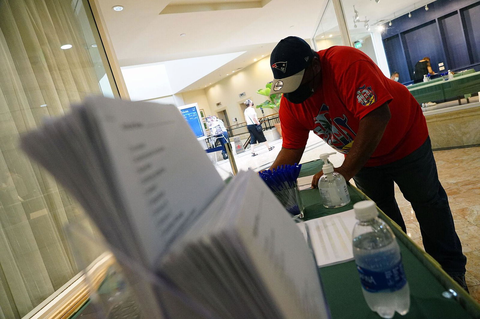 A retiree picks up an application at the reception booth during a job fair hosted by Landscape Management Systems at the Hilton Guam Resort & Spa last month.