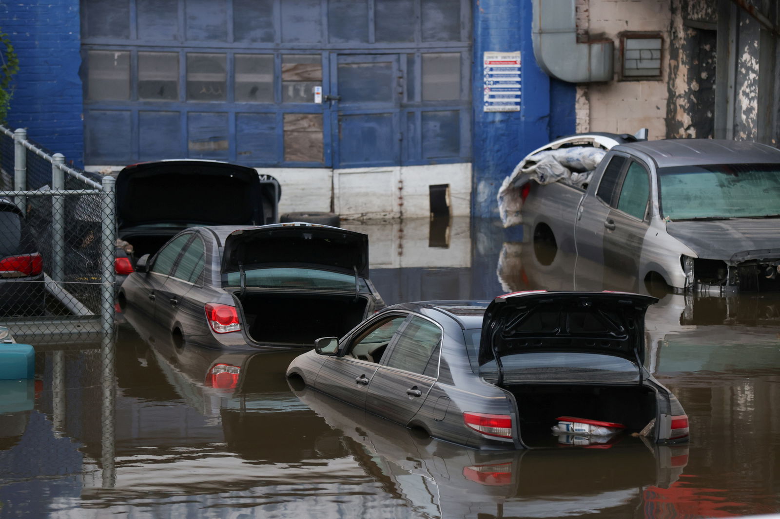 Cars sit in water after flooding on the Major Deegan Expressway spilled over into the neighboring street and flooded a parking lot, when the remnants of Tropical Storm Ida brought drenching rain and the threat of flash floods and tornadoes to parts of the northern mid-Atlantic, in the Bronx borough of New York City on Sept. 2, 2021. 