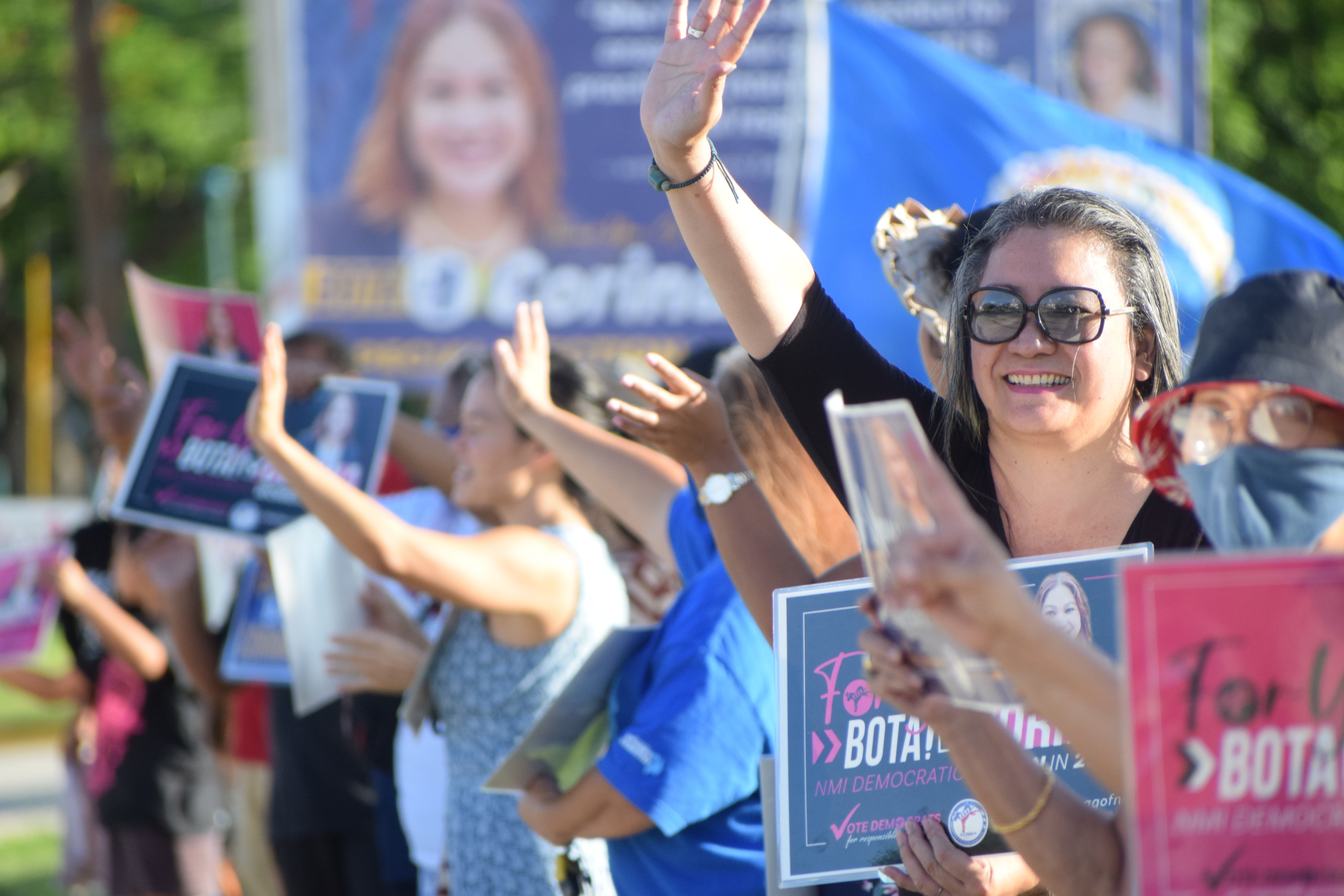 Sen. Edith Deleon Guerrero joins other Democrats and supporters of Corina Magofna in waving at motorists.