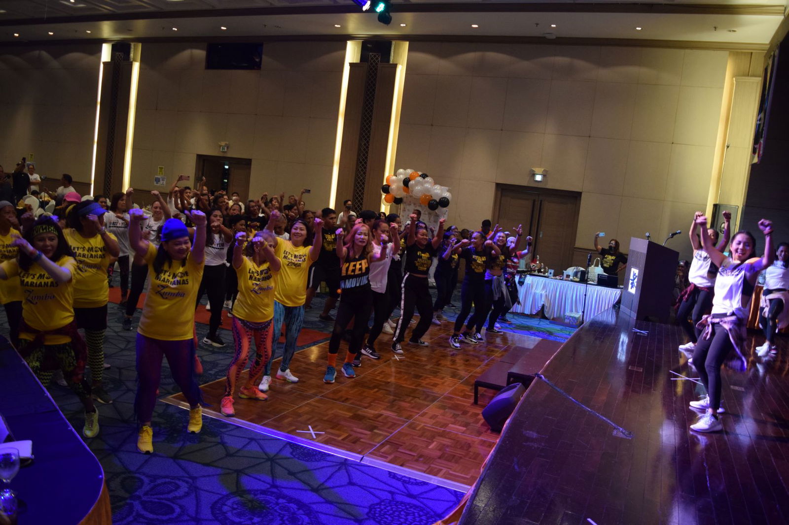 The M2 "shadower" and members, right, lead the Zumba marathon during M2 Fitness’s first anniversary celebration at Saipan World Resort on Saturday