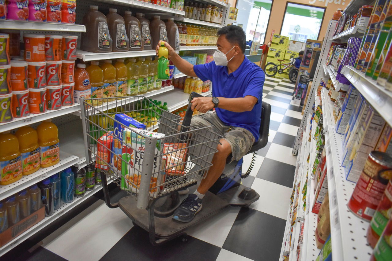 A veteran uses a motorized shopping cart at Triple J's Payless Super Fresh & Truckload Store.