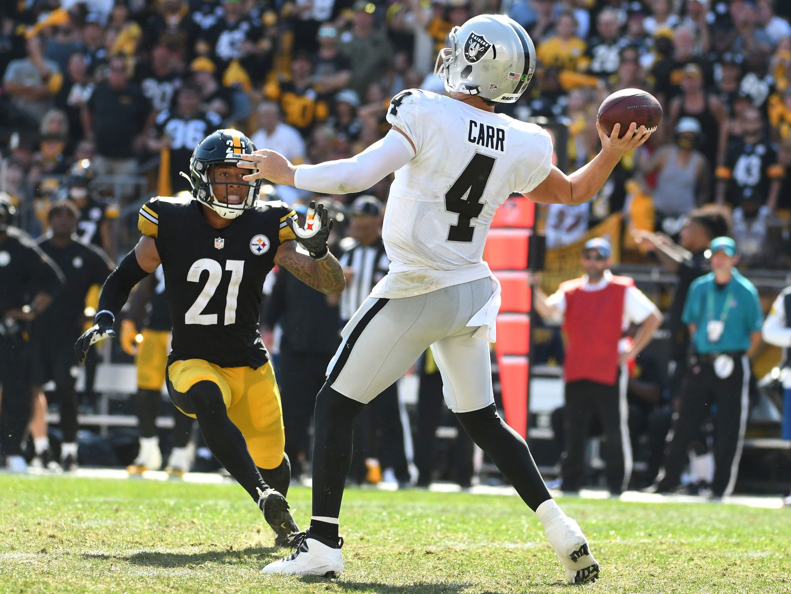 Las Vegas Raiders quarterback Derek Carr throws a 61 yard touchdown as the Pittsburgh Steelers Tre Norwood applies pressure during the fourth quarter at Heinz Field in Pittsburgh, Pennsylvania on Sept. 19, 2021. The Raiders won 26-17.
