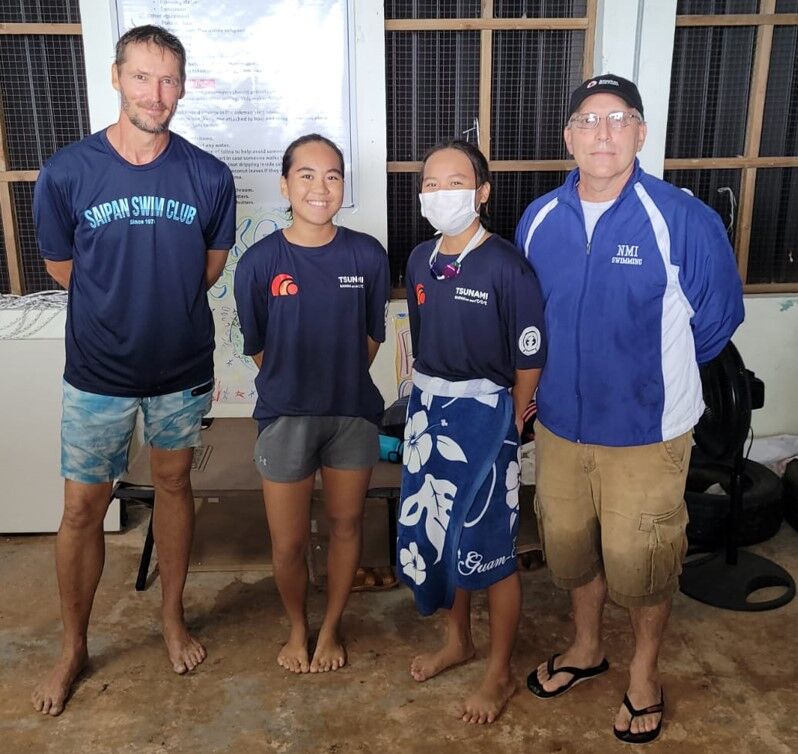 Asaka and Shoko Litulumar pose for a photo with Saipan Swim Club head coach Richard Sikkel and Northern Mariana Islands Swimming Federation vice president John Hirsh  during the awards ceremony of the SSC Triple Crown Open Water Swim Series on Saturday at Guma Sakman.