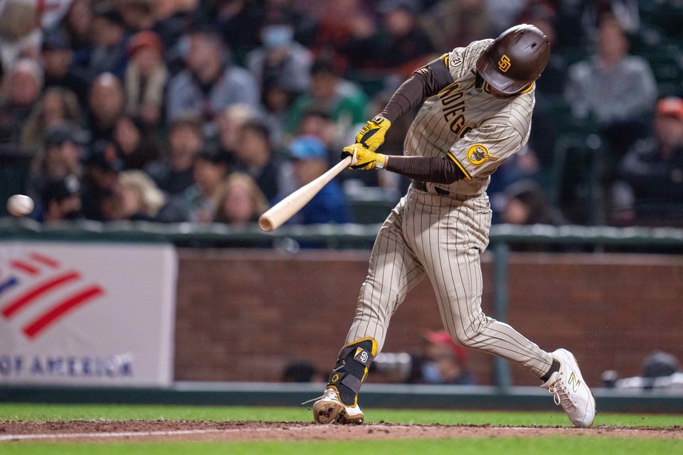 San Diego Padres second baseman Adam Frazier (12) singles to right field against the San Francisco Giants during the fifth inning at Oracle Park in San Francisco, California on Sept. 15, 2021.