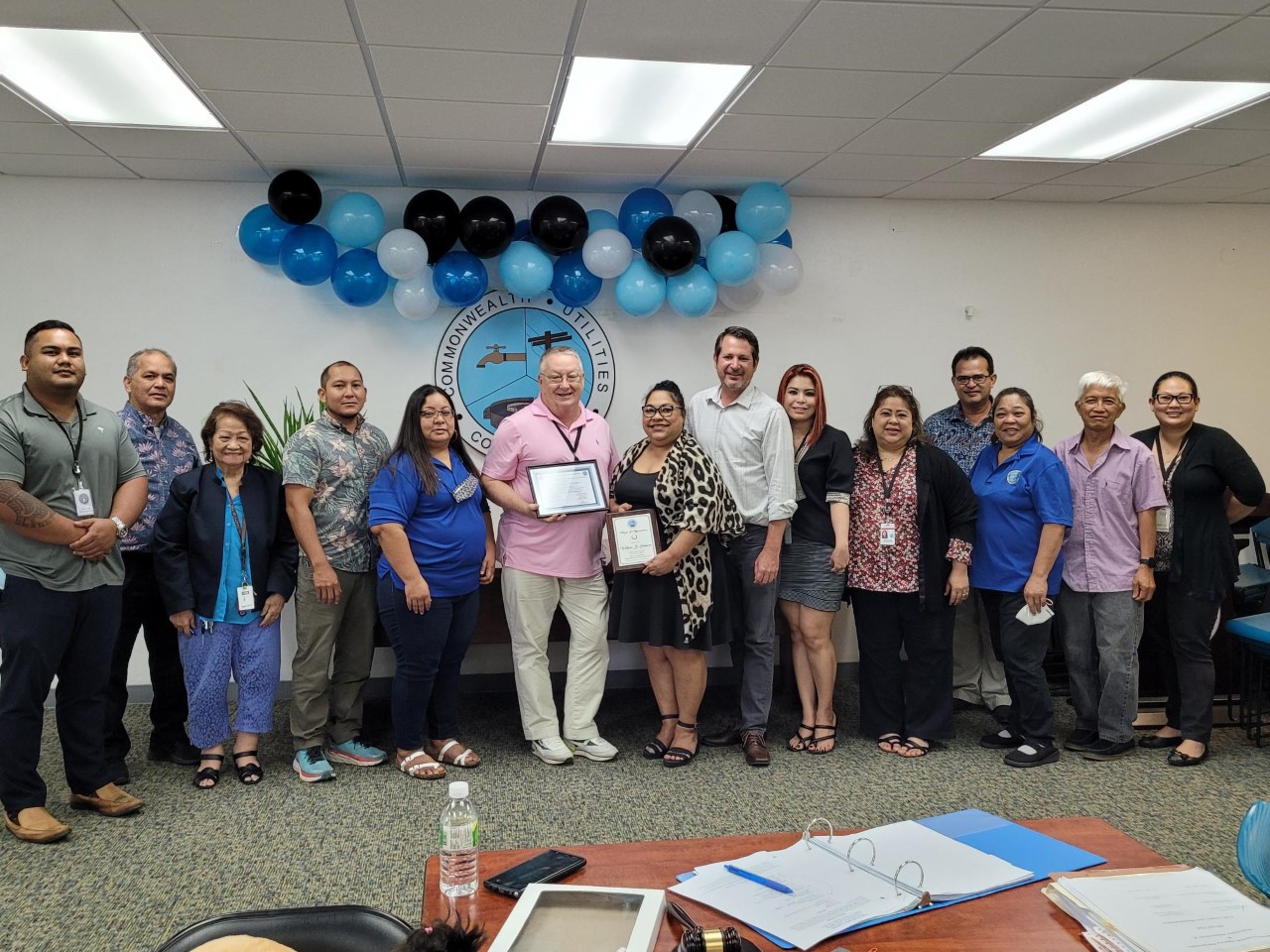 Outgoing Commonwealth Utilities Corp.  Deputy Executive Director William Gilmore, center, receives a framed certificate of appreciation from the CUC board and management team on Friday. Gilmore was hired by CUC in Nov. 2016.