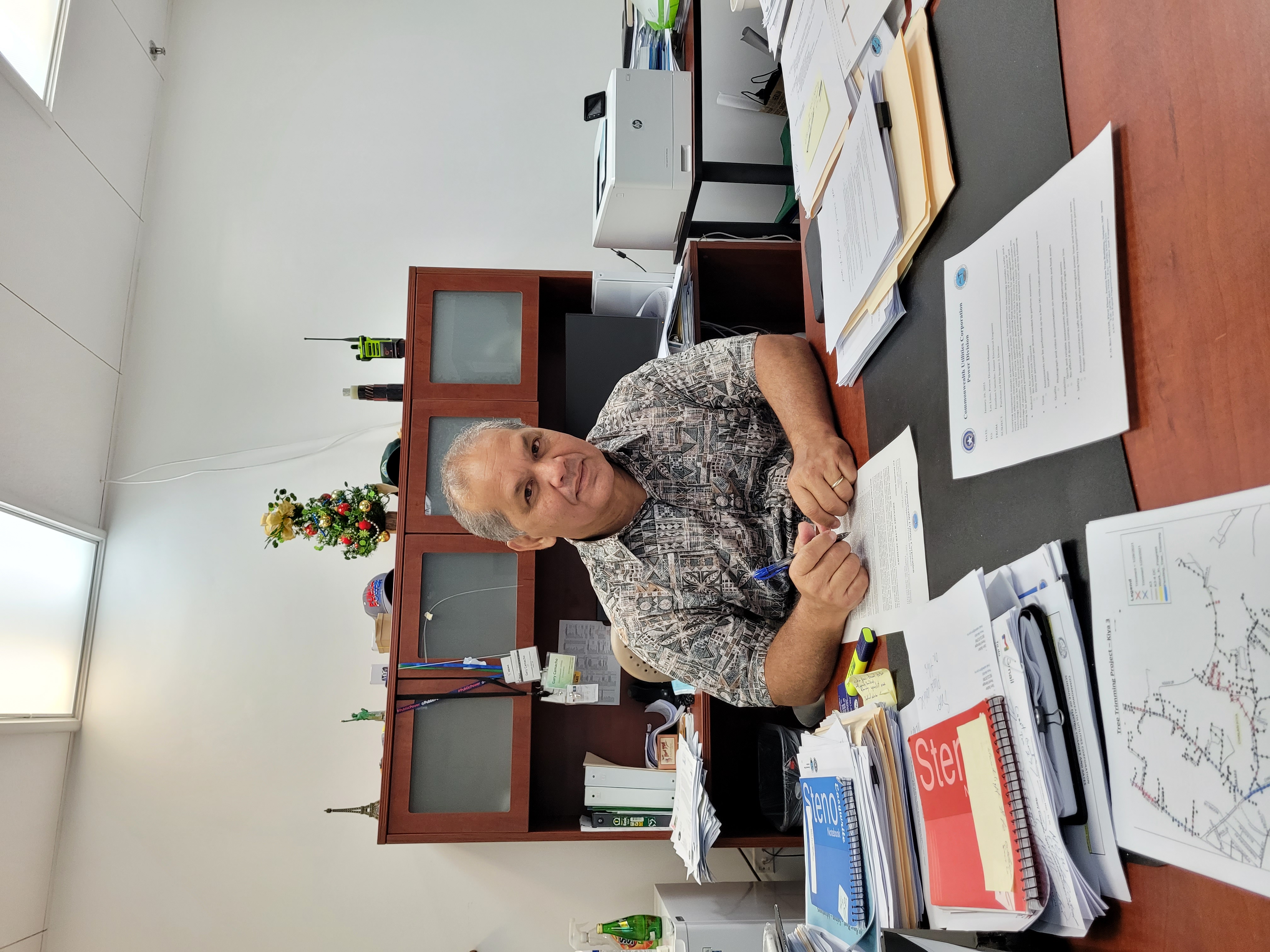 Commonwealth Utilities Corporation Executive Director Gary Camacho poses for a photo in his office.