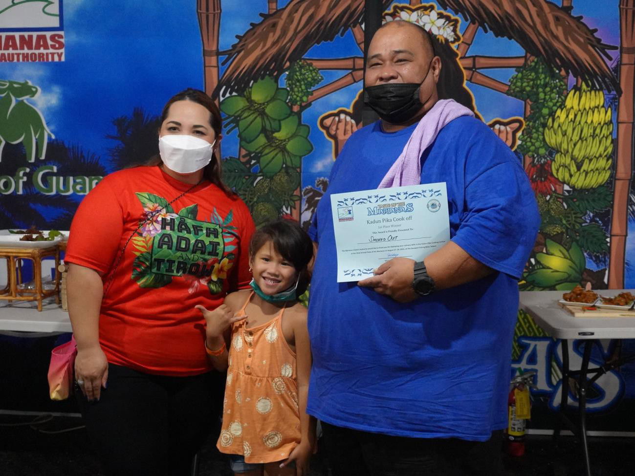 Marianas Visitors  Authority Managing Director Priscilla M.  lakopo  left,  awards first place and $500 to Smoked Out in the Kadun Pika Cooking Contest.