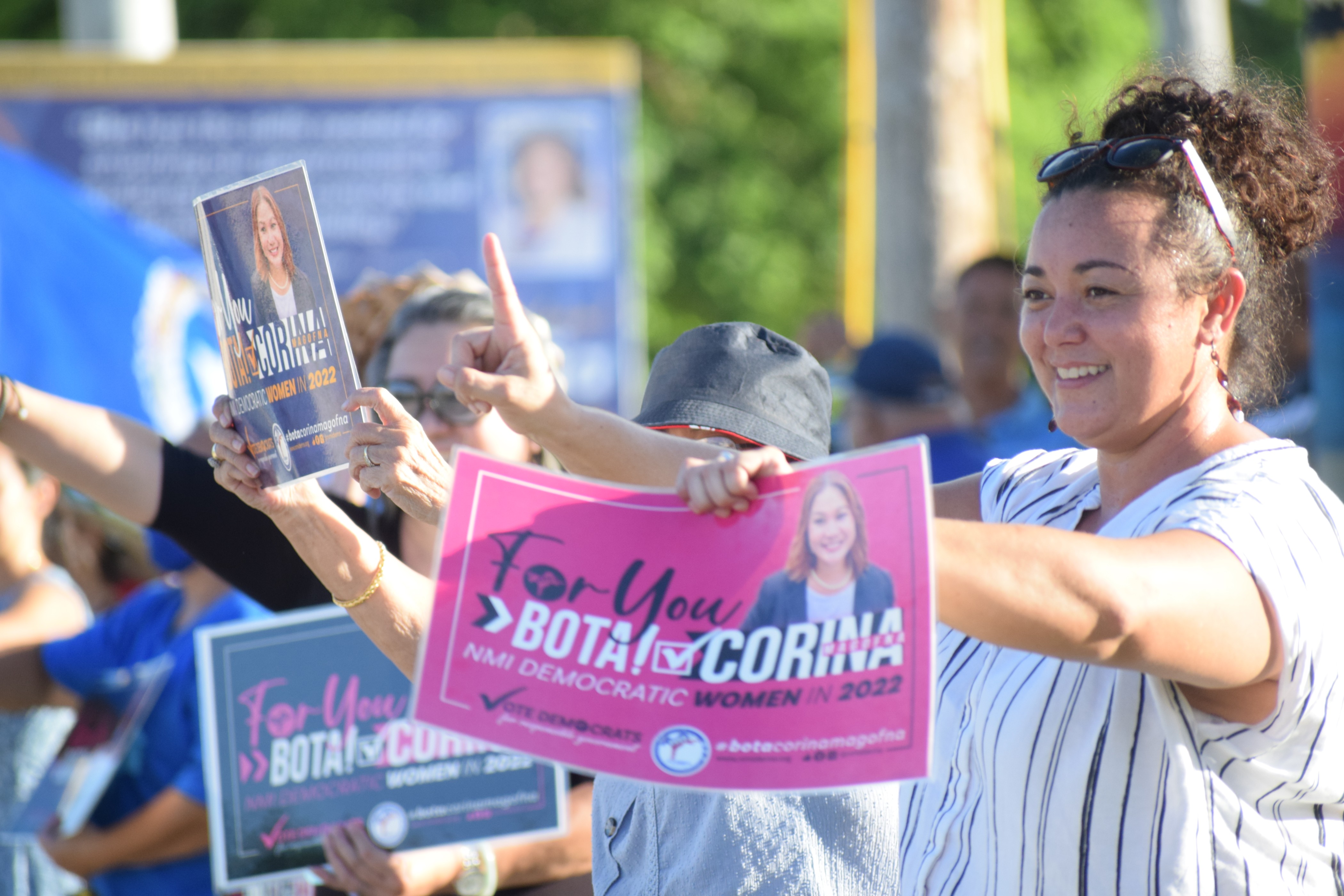 Rep. Sheila Staffler holds a campaign sign and flashes the number-one sign. Precinct 3 House candidate Corina Magofna is number one on the Oct. 16 special election ballot.