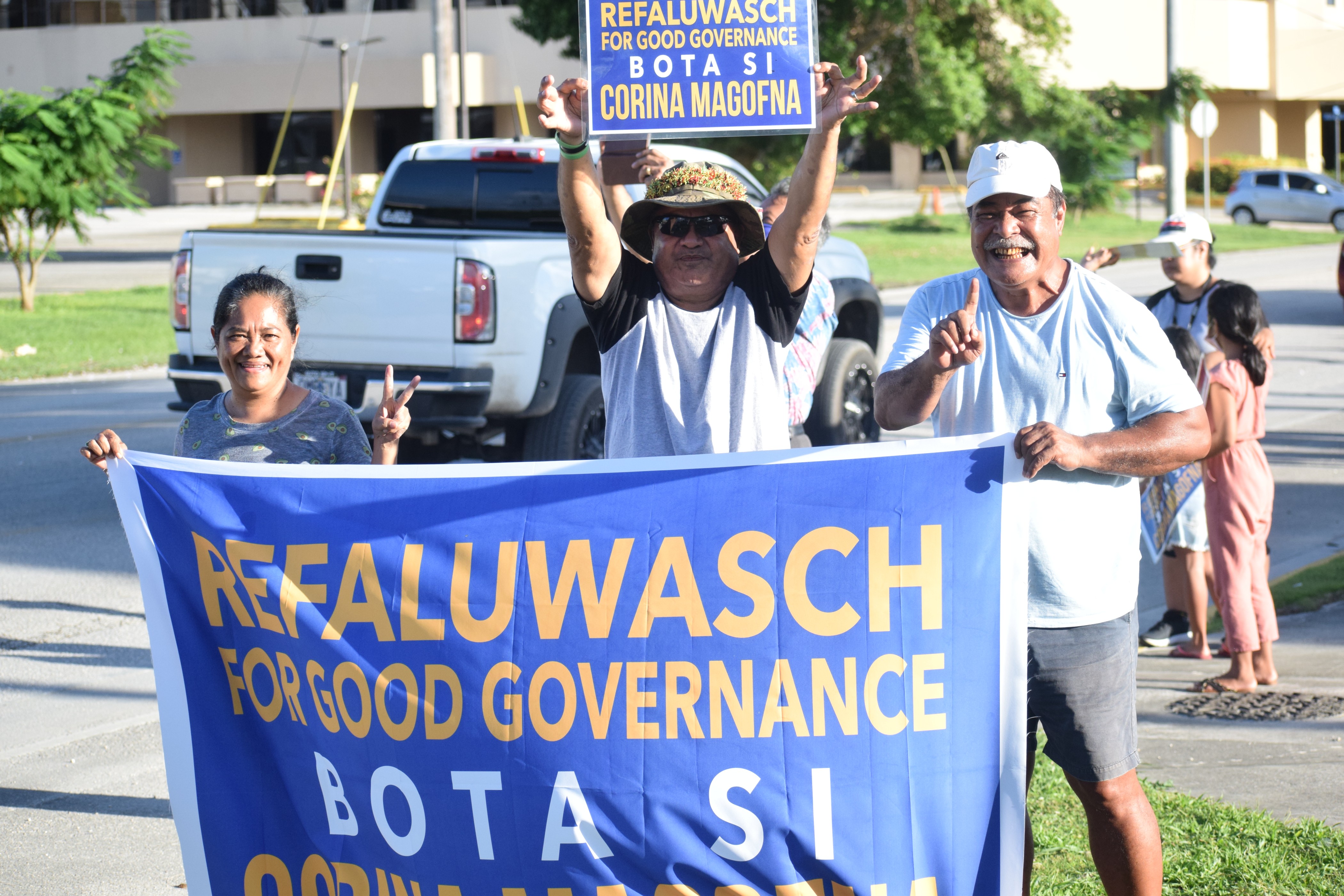 Refaluwasch for Good Governance led by Felix Nogis, right, hold a campaign banner.
