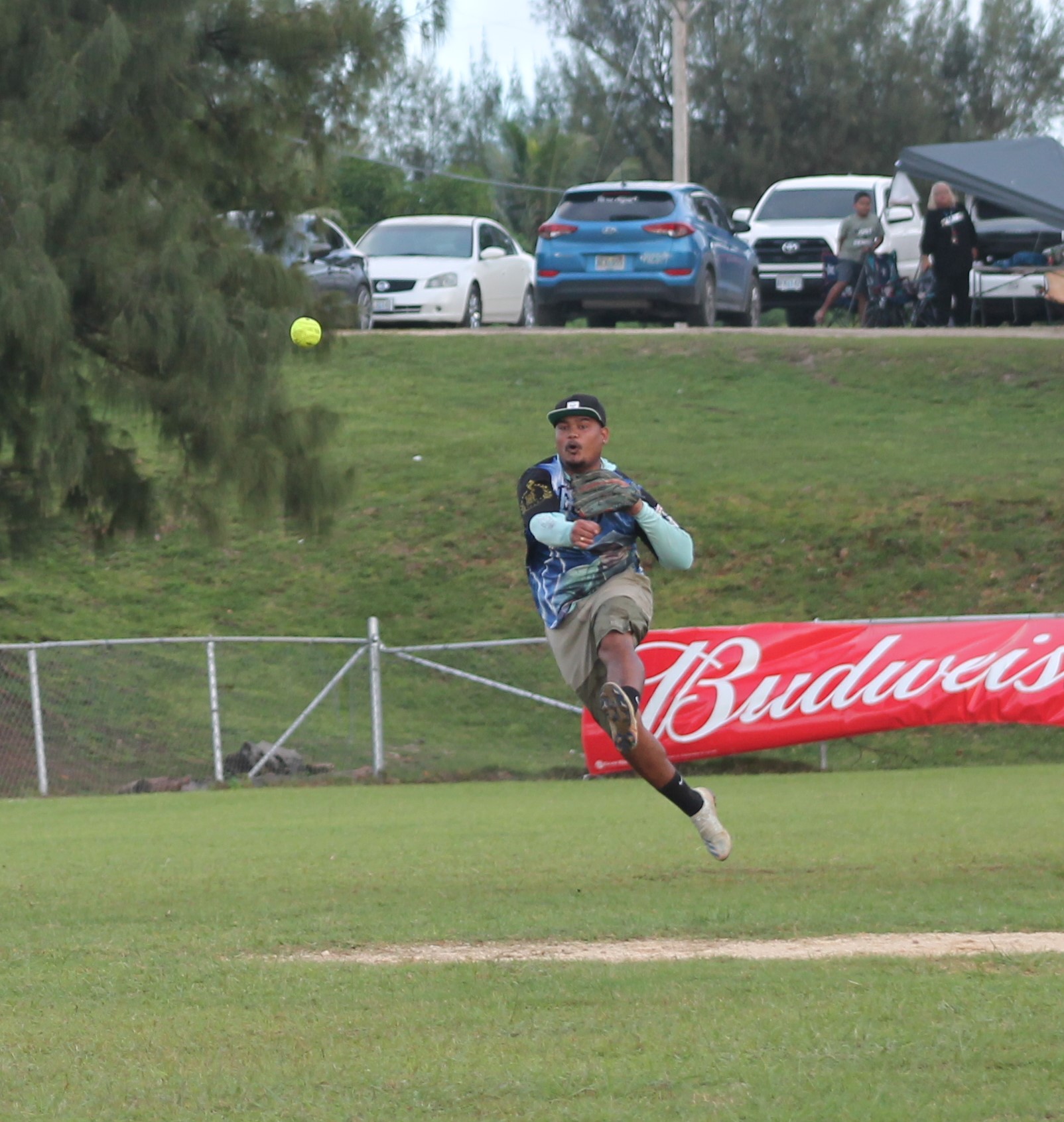 Pues OK's Franko throws to first base for the out during a King of the Diamond Labor Day Softball Tournament game at the Capital Hill ballfield on Sunday.