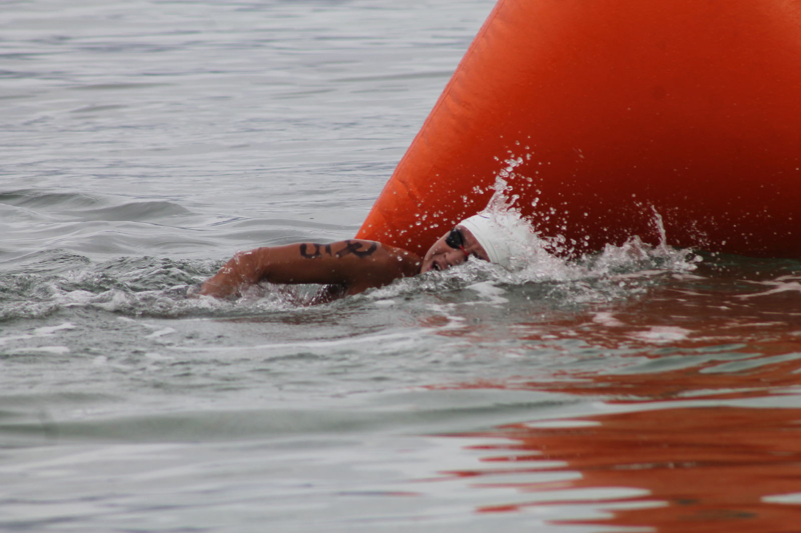 Juhn Tenorio pushes through as he passes the final buoy  during the Saipan Swim Club Triple Crown Open Water Swim Series on Saturday at Guma Sakman.
