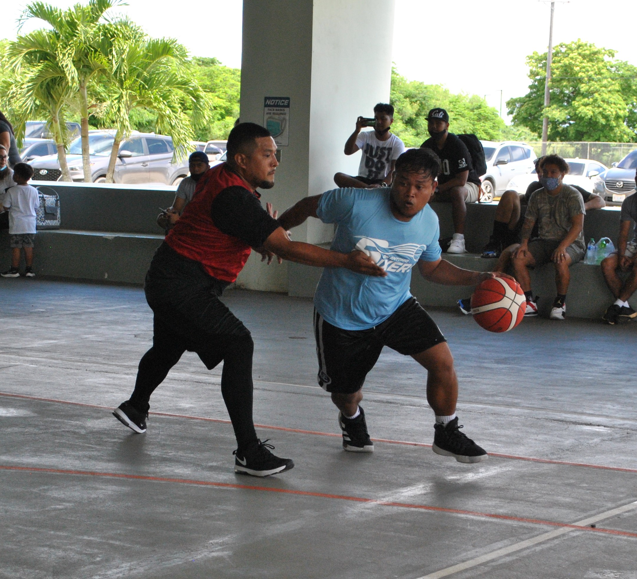 The Sixers' Jack Aranda drives past Pacific Auto's James Camacho during a game of the NMI Rollers Basketball Association Men's Tournament on Saturday at the Koblerville gym.