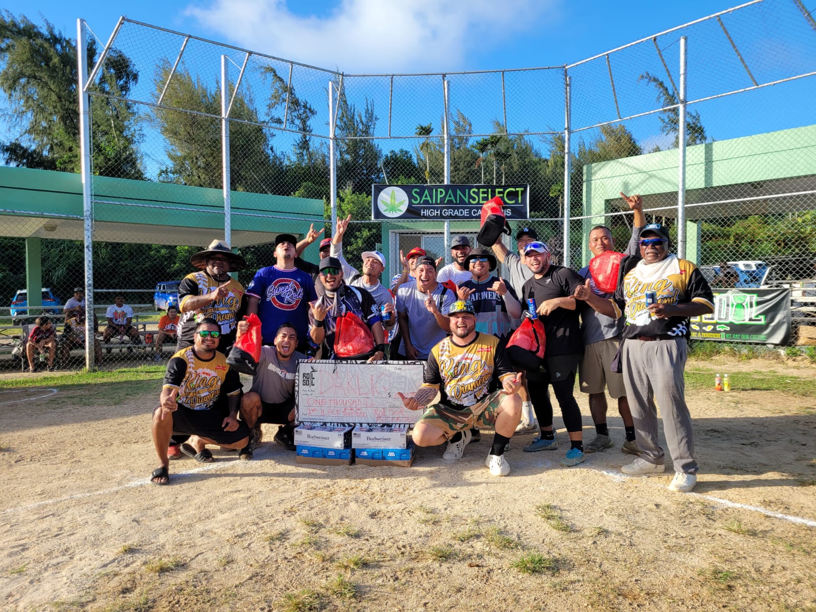 KLIQ team members celebrate after receiving the $1,000 first prize for topping the Budweiser King of the Diamond Labor Day Softball Tournament on Monday at the Capital Hill ballfield.