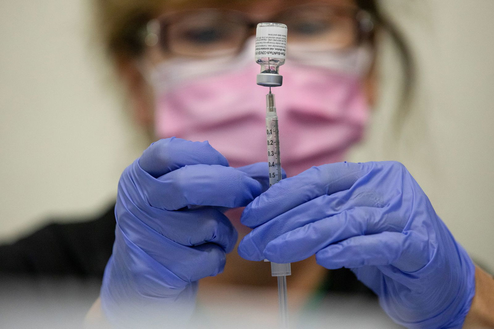 A nurse fills up syringes for patients as they receive their coronavirus disease booster vaccination during a Pfizer-BioNTech vaccination clinic in Southfield, Michigan on Sept. 29, 2021.
