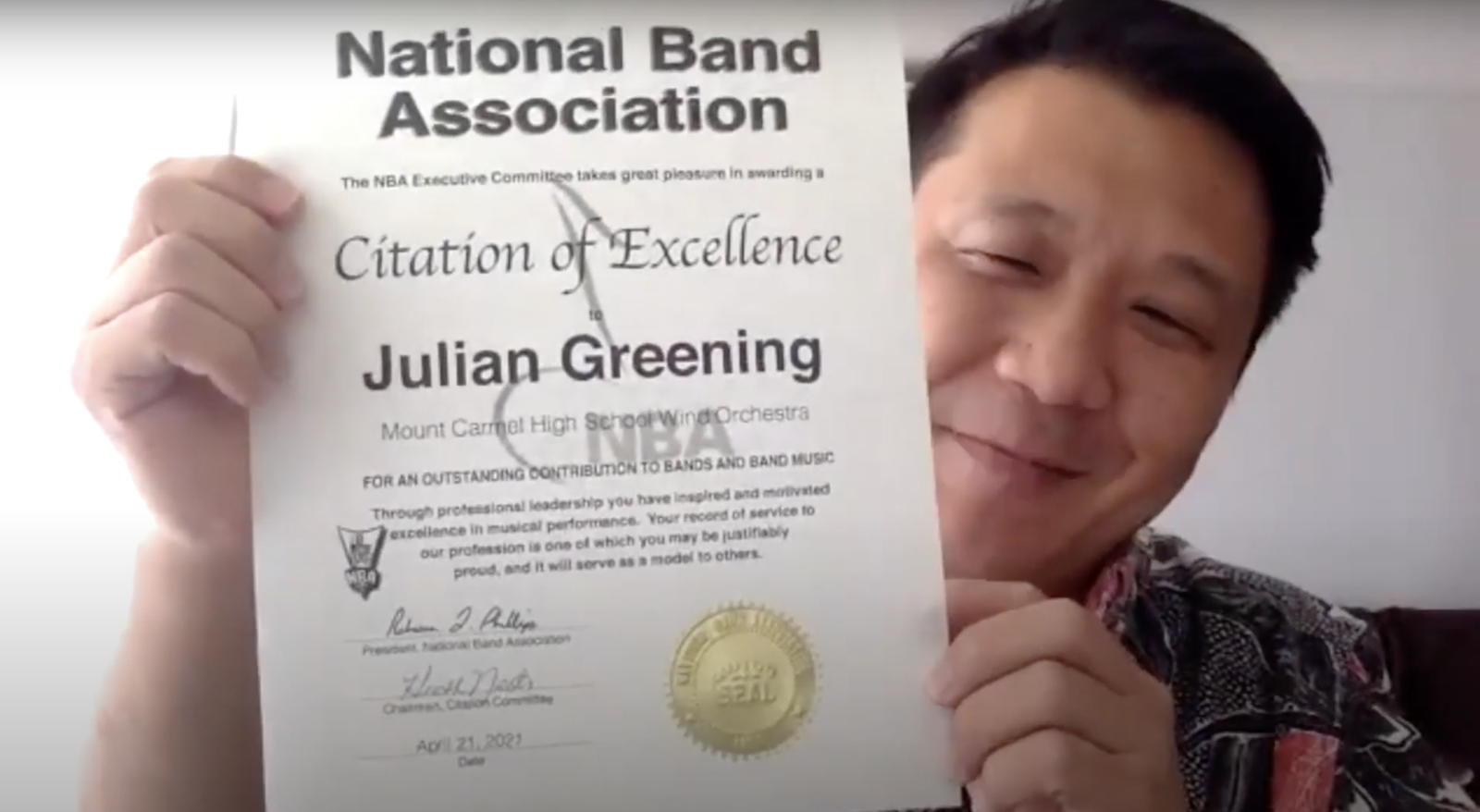 The National Band Association’s high school representative, Chad Kamei, presents the Citation of Excellence certificate to Mount Carmel School band director Mr. Julian Greening during a virtual ceremony.