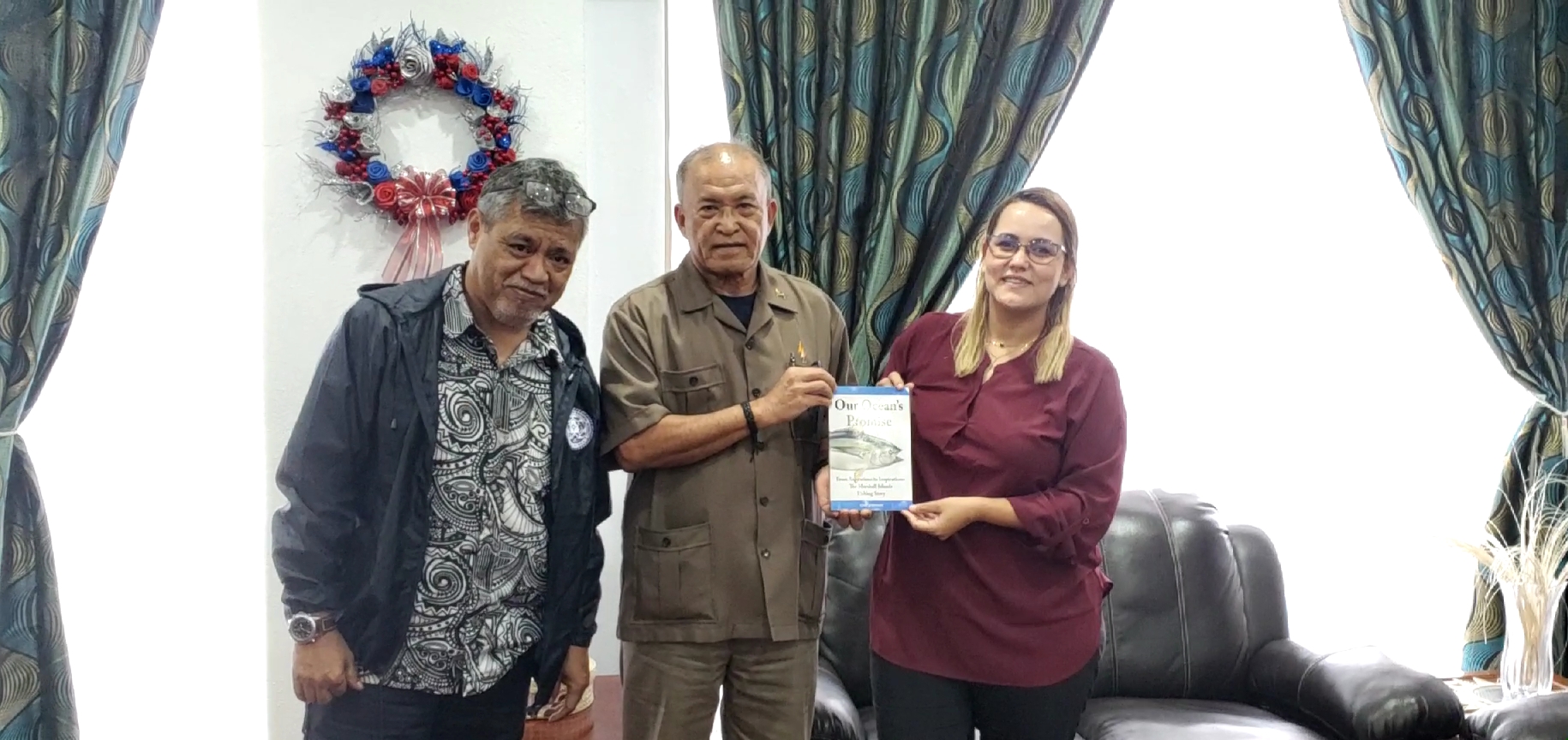 Marshall Islands President David Kabua, center, receives a copy of the new book, “Our Ocean's Promise: From Aspirations to Inspirations — The Marshall Islands Fishing Story,” from Marshall Islands Marine Resources Authority Director Glen Joseph, left, and Marshall Islands Environmental Protection Authority General Manager Moriana Phillip.