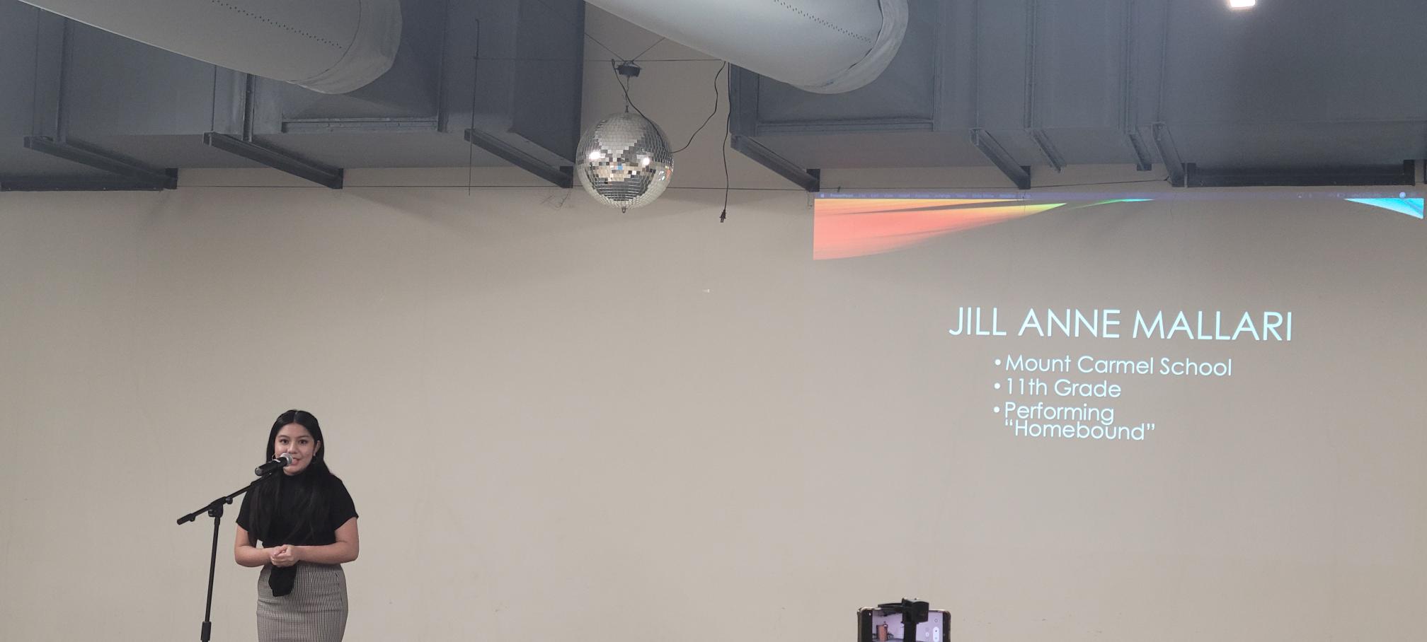 Senior division winner Jill Anne Mallari recites her original poem, "Homebound."