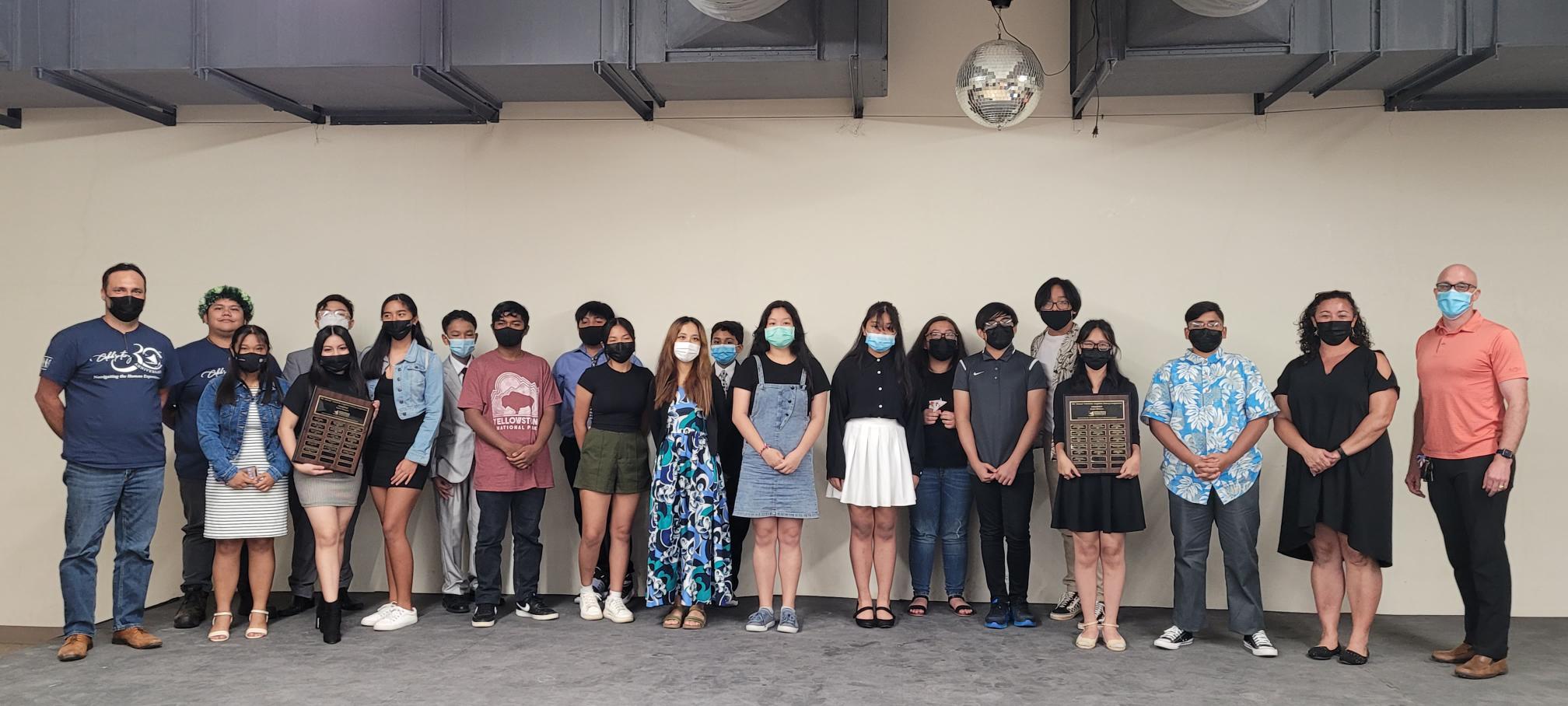 Competitors, judges, and the master of ceremonies in this year's poetry competition pose for a group photo.