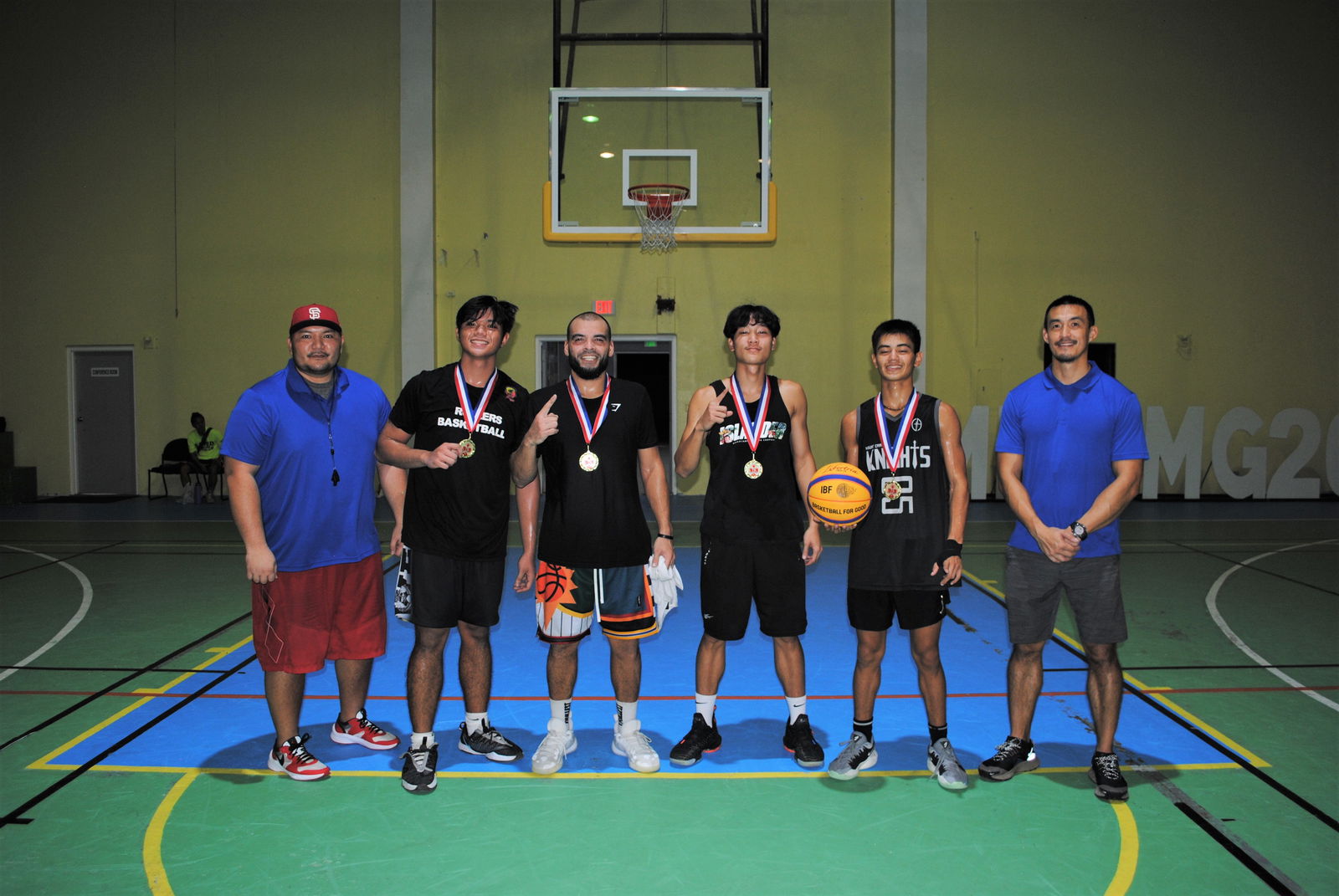End Game team members pose with their first-place medals and NMI Basketball Federation officials David John Apatang and James Lee.