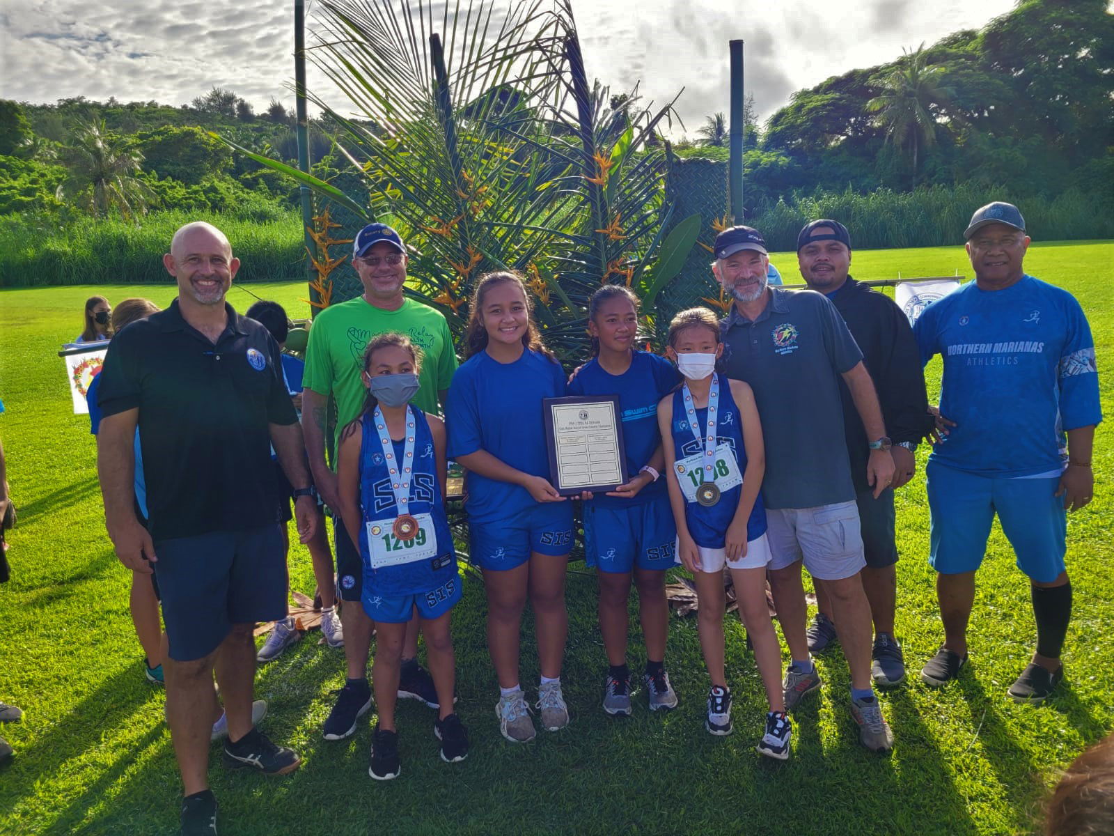 The Saipan International School middle school girls pose with their championship trophy during the  awards ceremony of the NMA-PSS All School Cross Country Saturday at the Saipan Country Club.