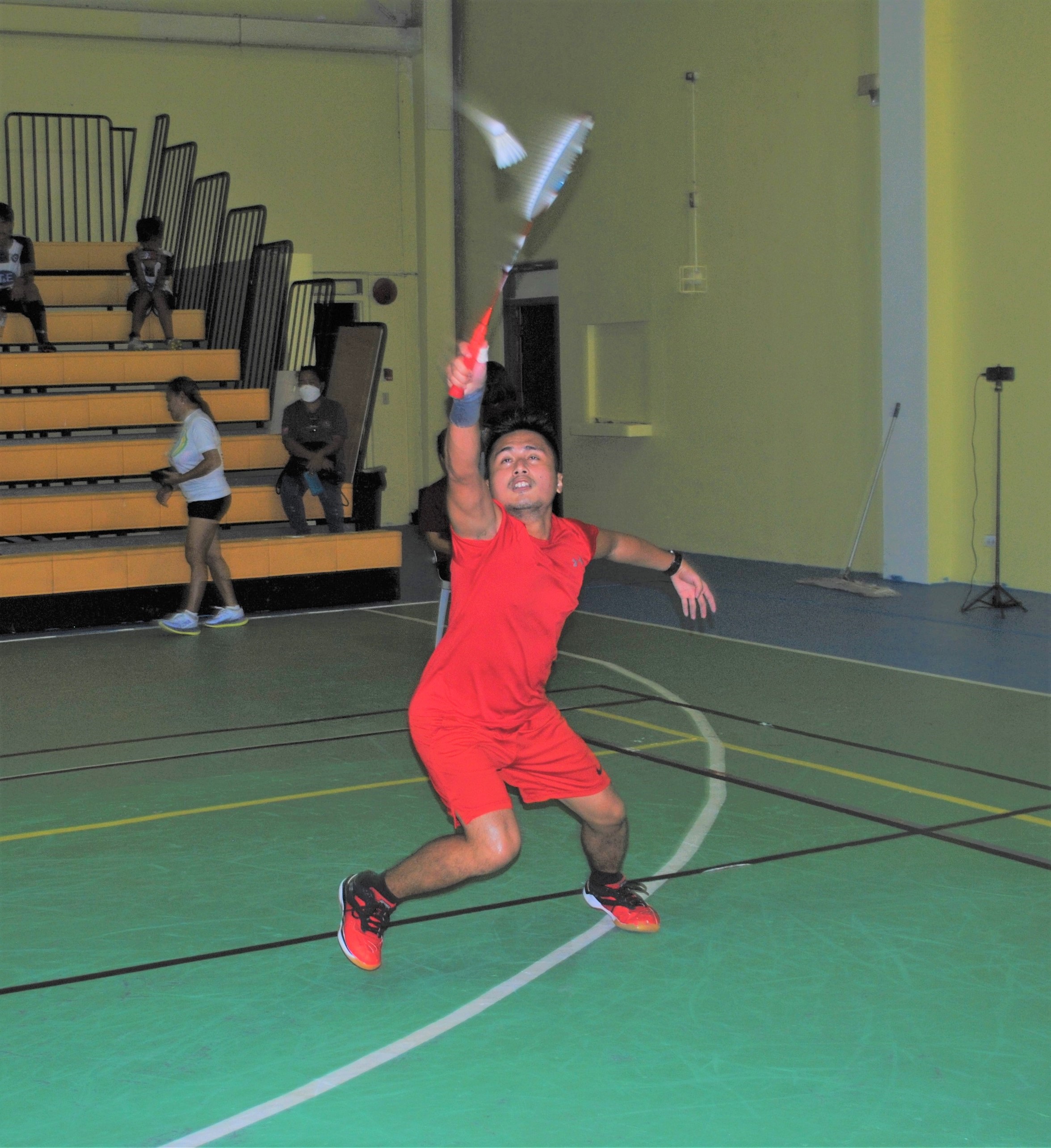 Andreau Galvez stretches for the backhand return during an A Men's Singles game of the TakeCare Badminton Open Tournament Friday at the Ada gym.