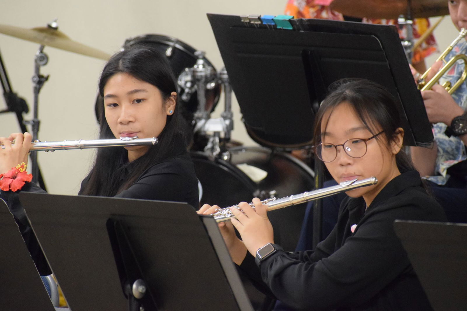 MHS Chorale and Concert Band. flutists perform on stage.