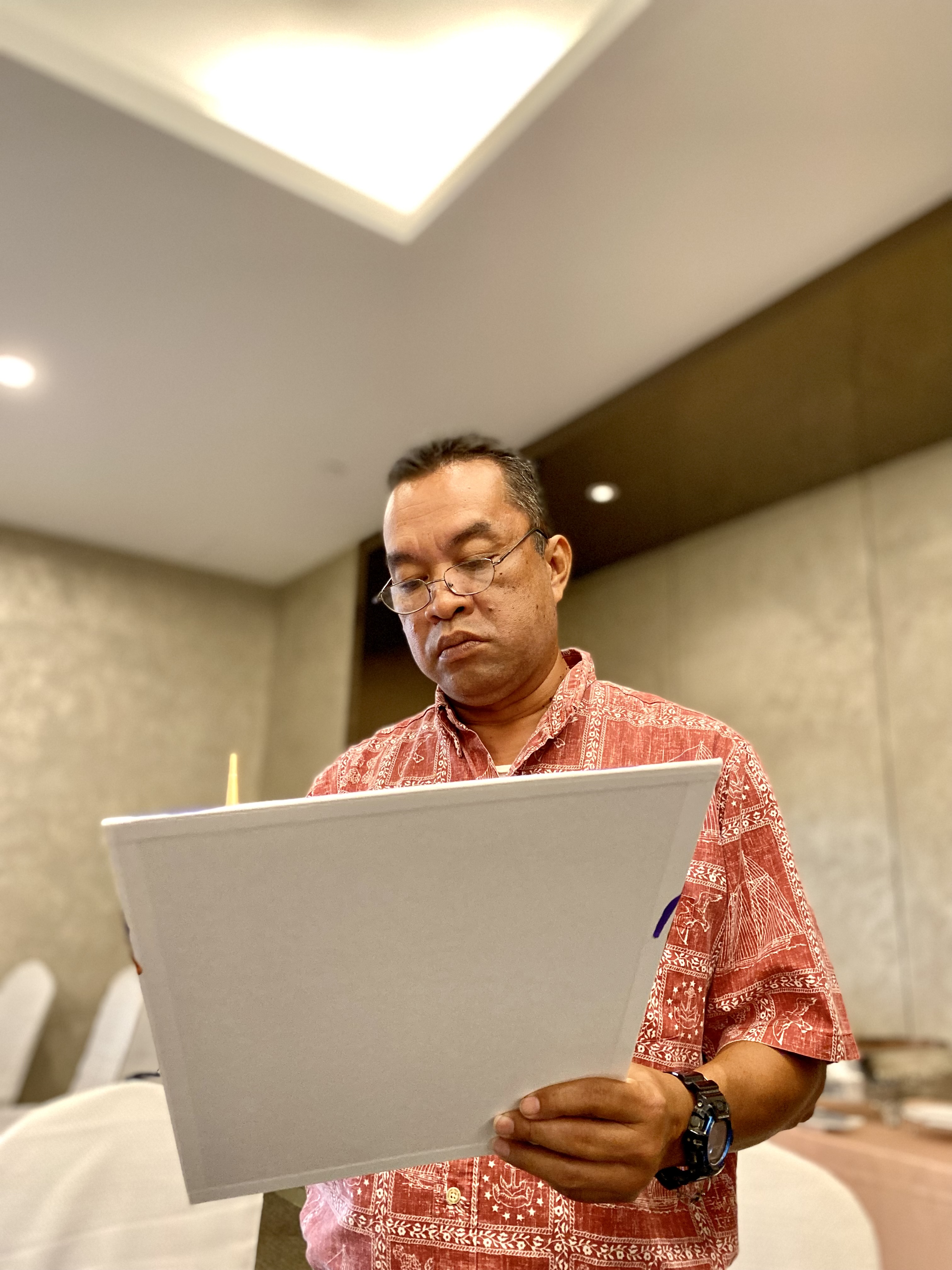 Saipan Southern High School Principal Vince Dela Cruz is immersed in his artwork.