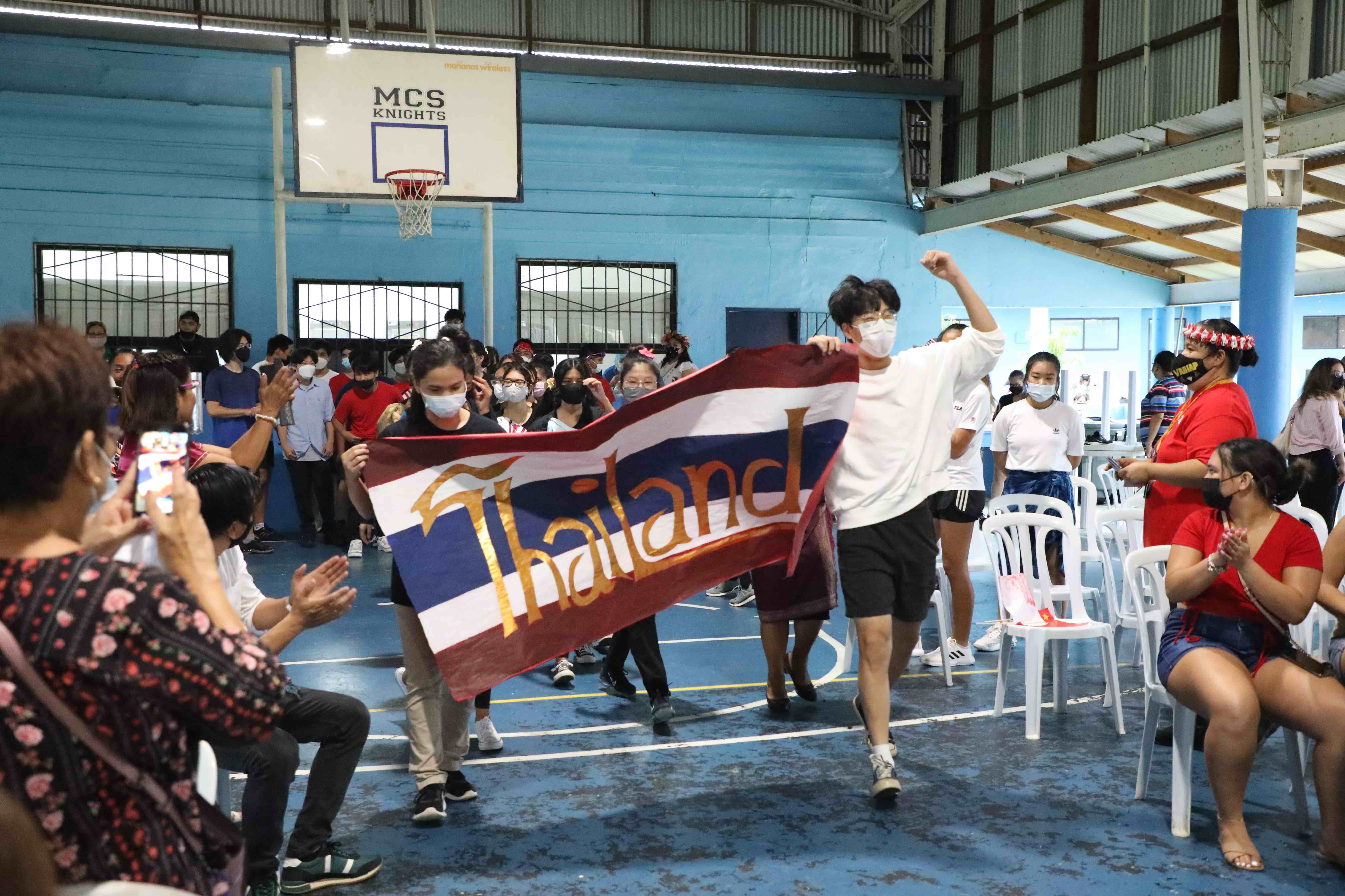Mount Carmel School’s freshmen class march to the performance area proudly representing Thailand.