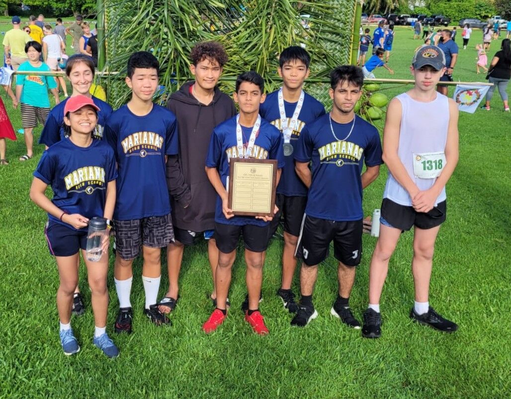 The boys of Marianas High School pose with their championship trophy during the awards ceremony Saturday of the NMA-PSS All School Cross Country at the Saipan Country Club.