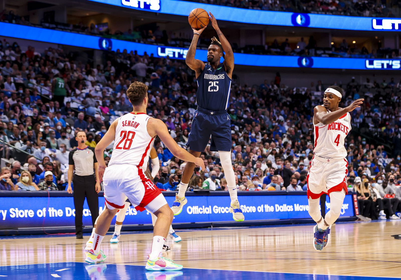 Dallas Mavericks forward Reggie Bullock (25) shoots over Houston Rockets center Alperen Sengun (28) during the first half at American Airlines Center in Dallas, Texas on Oct 26, 2021.