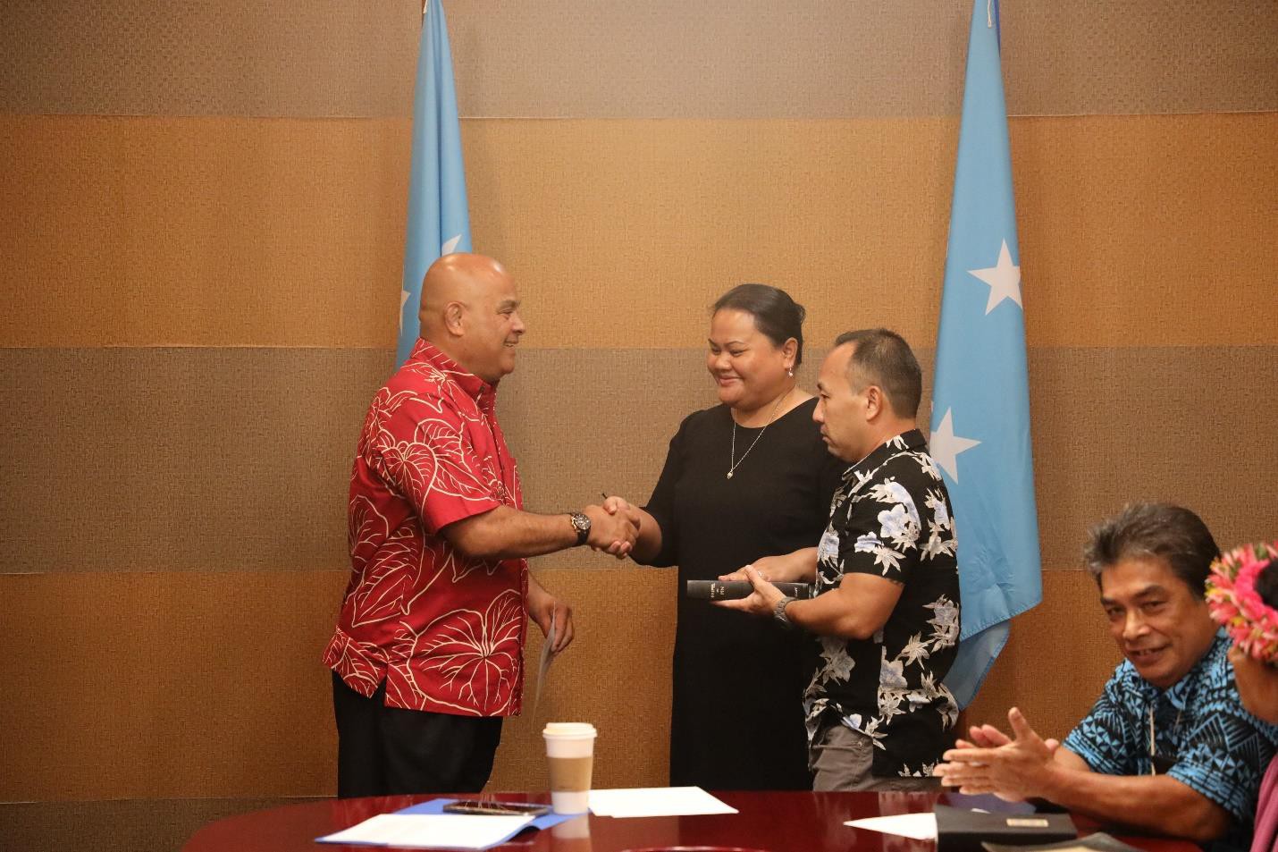 FSM Department of Resources & Development Secretary Elina Akinaga shakes hands with  FSM President David Panuelo after taking  her oath of office.