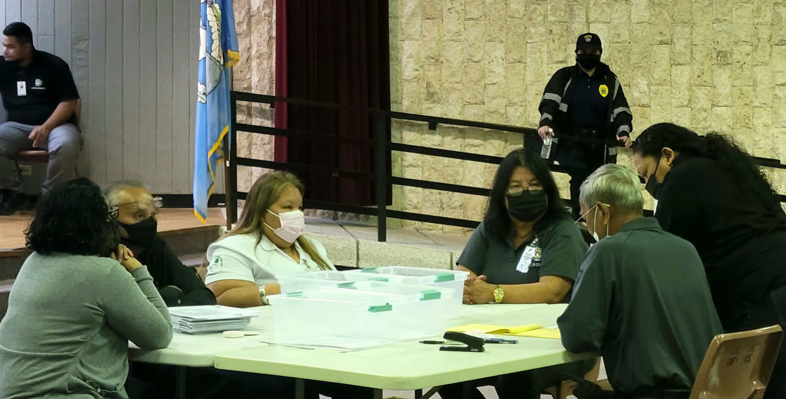 Commonwealth Election Commission board members and executive director Kayla S. Igitol meet at the multi-purpose center on Saturday evening just before the manual tabulation of the Precinct 3 House special election ballots.