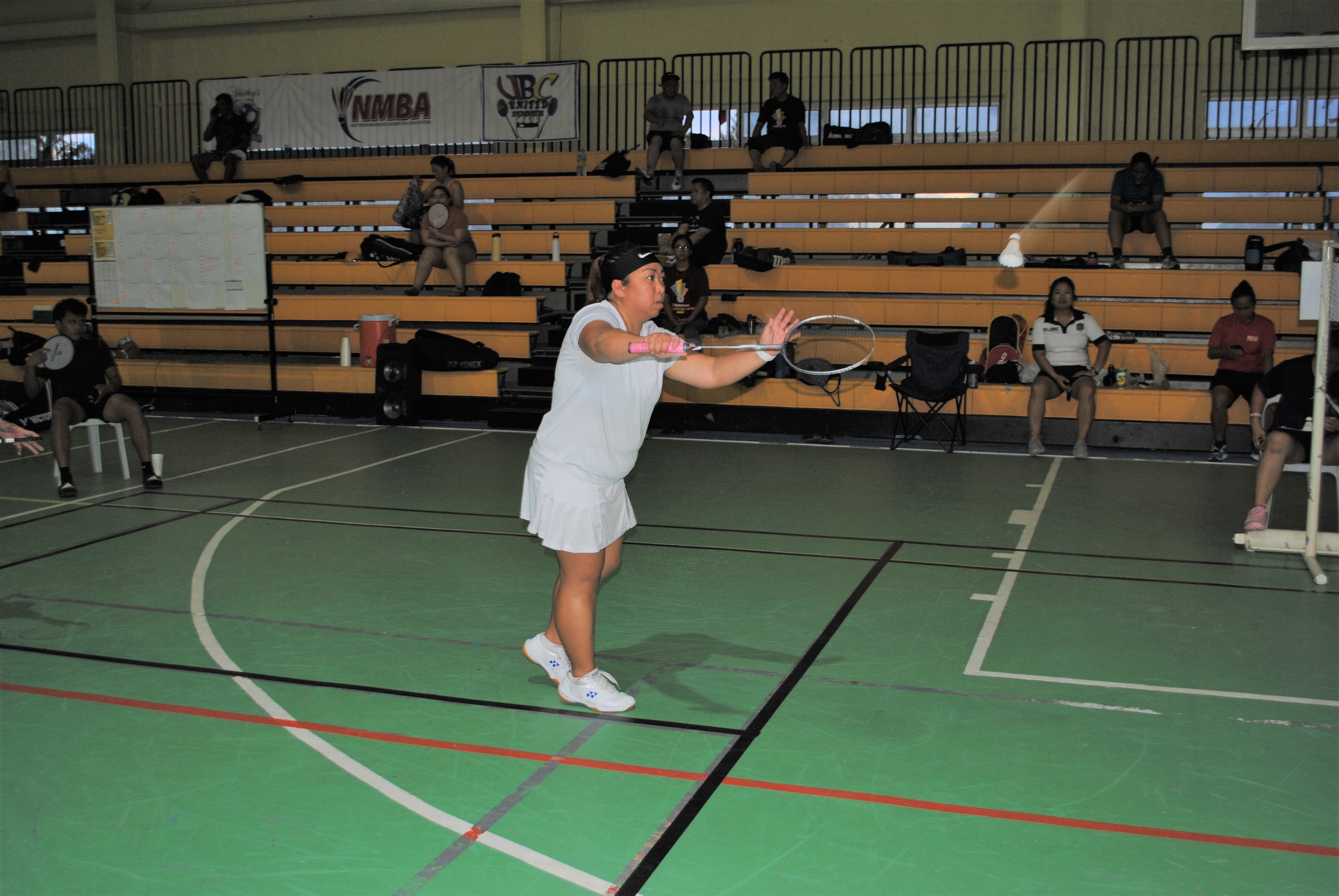 Windy Fernandez attempts a serve during  a B Women's Single  game of the TakeCare Badminton Open Saturday at the Ada gym.