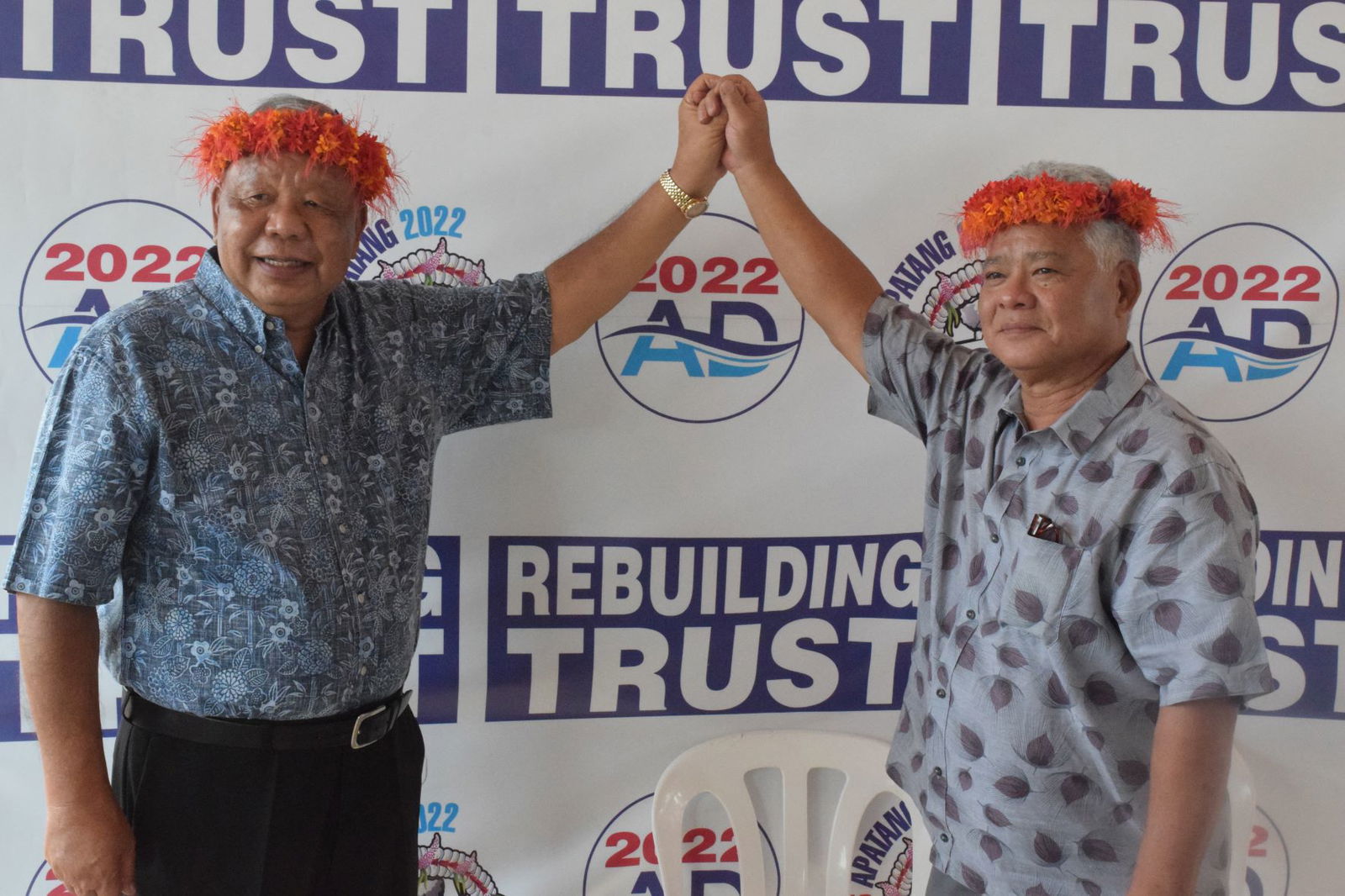 Lt. Gov. Arnold I. Palacios, right, and Saipan Mayor David M. Apatang raise each other’s  hands after announcing their candidacies for the 2022 gubernatorial election at the Minatchom Atdao Pavilion in Susupe on Thursday.