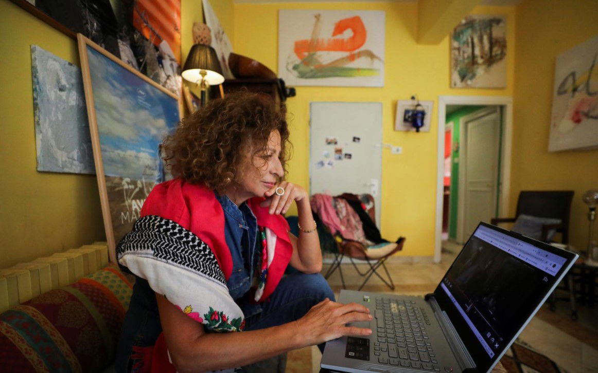 Palestinian cultural consultant and actress Huda al Imam watches her film "Ave Maria," which is part of the new "Palestinian Stories" collection launched on Netflix, at her home in the Sheikh Jarrah neighborhood, Jerusalem on Oct. 14, 2021. 