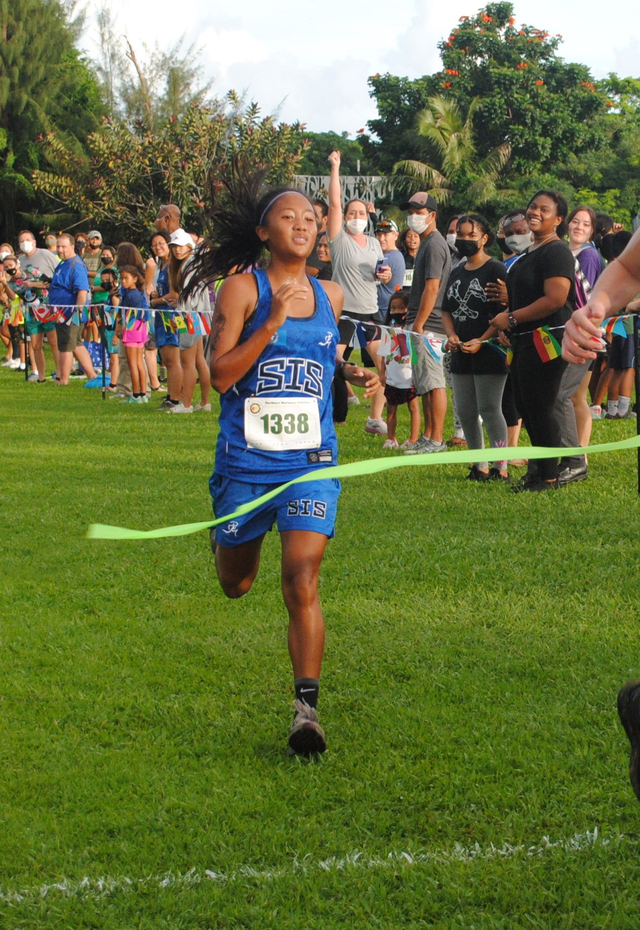 Saipan International School Kaithlyn Chavez smiles as she crosses the finish line of the Girls High School Division of the NMA-PSS All School Cross Country Saturday at the Saipan Country Club.