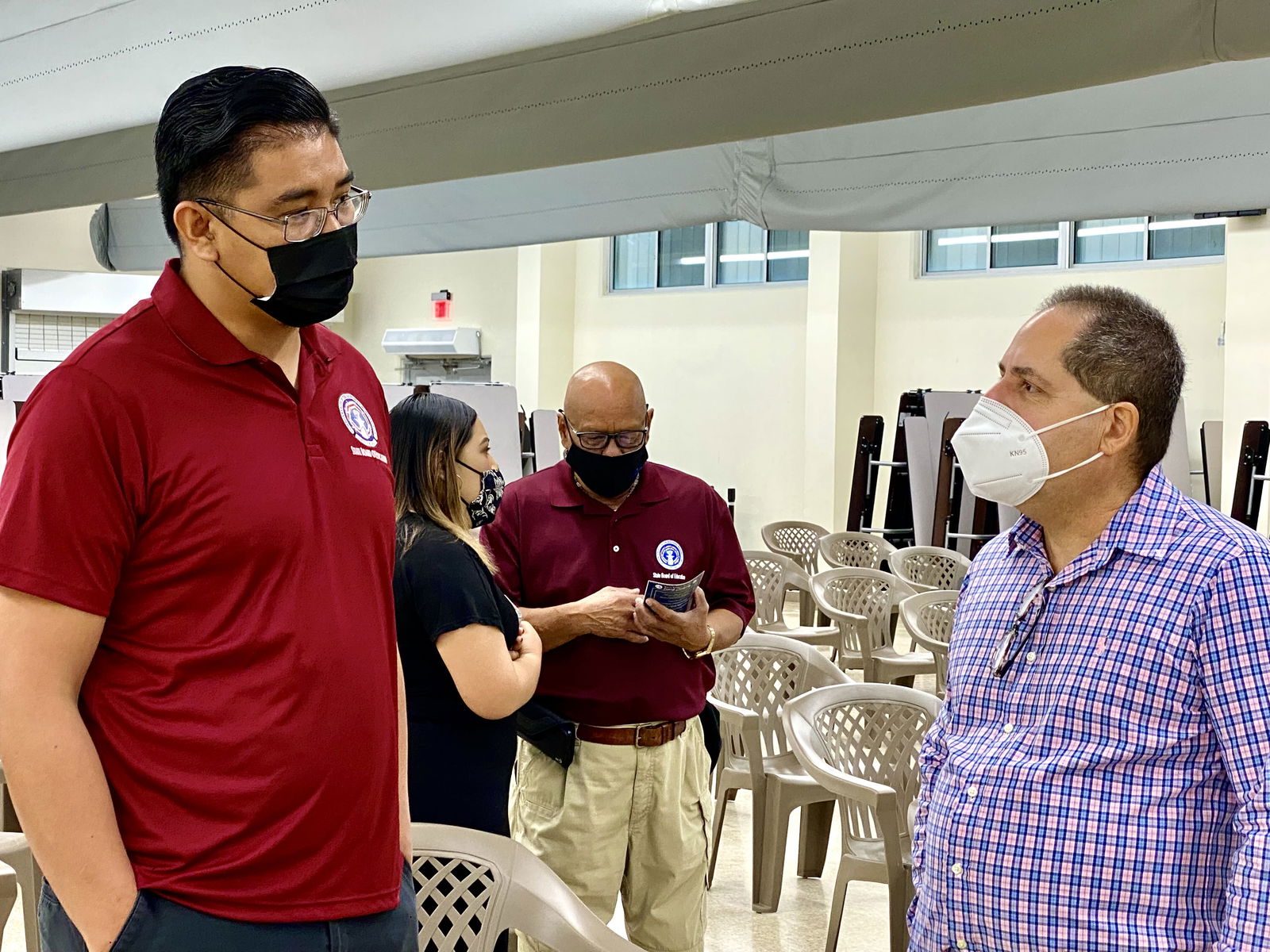 Board of Education member Antonio Borja talks with Micronesia Renewable Energy Chief Operations Officer Jeffrey Voacolo.