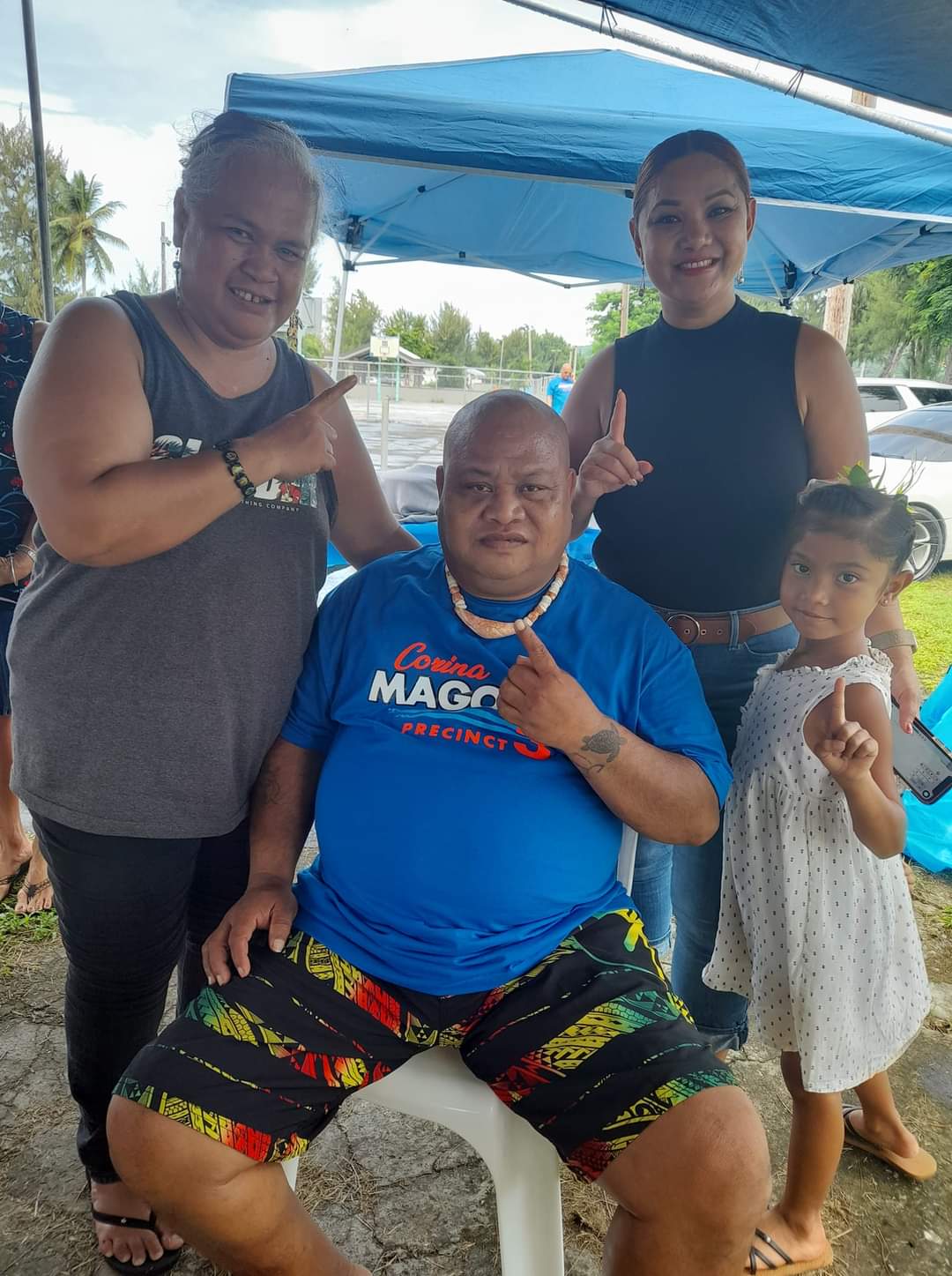Democrat Corina L. Magofna, 2nd right, and supporters flash the “number 1” sign. Magofna’s name is number one on the House special election ballot.