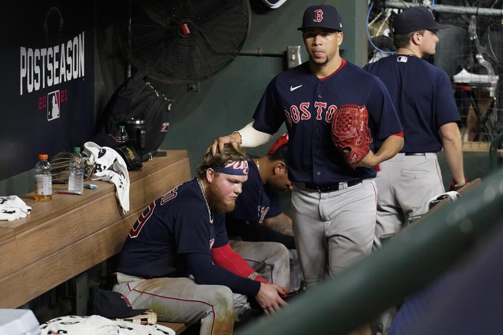 Boston Red Sox's Hansel Robles pats Alex Verdugo on the head after the team's loss to the Houston Astros in Game 6 of baseball's American League Championship Series on Friday in Houston. The Astros won 5-0, advancing to the World Series. 