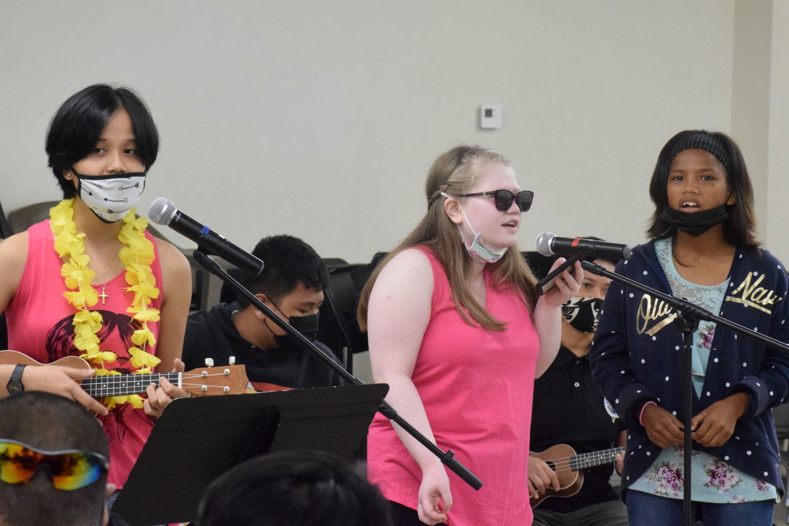 Jamille Pangelinan, Alexis Aldan, Jovinia Moses perform a musical number.