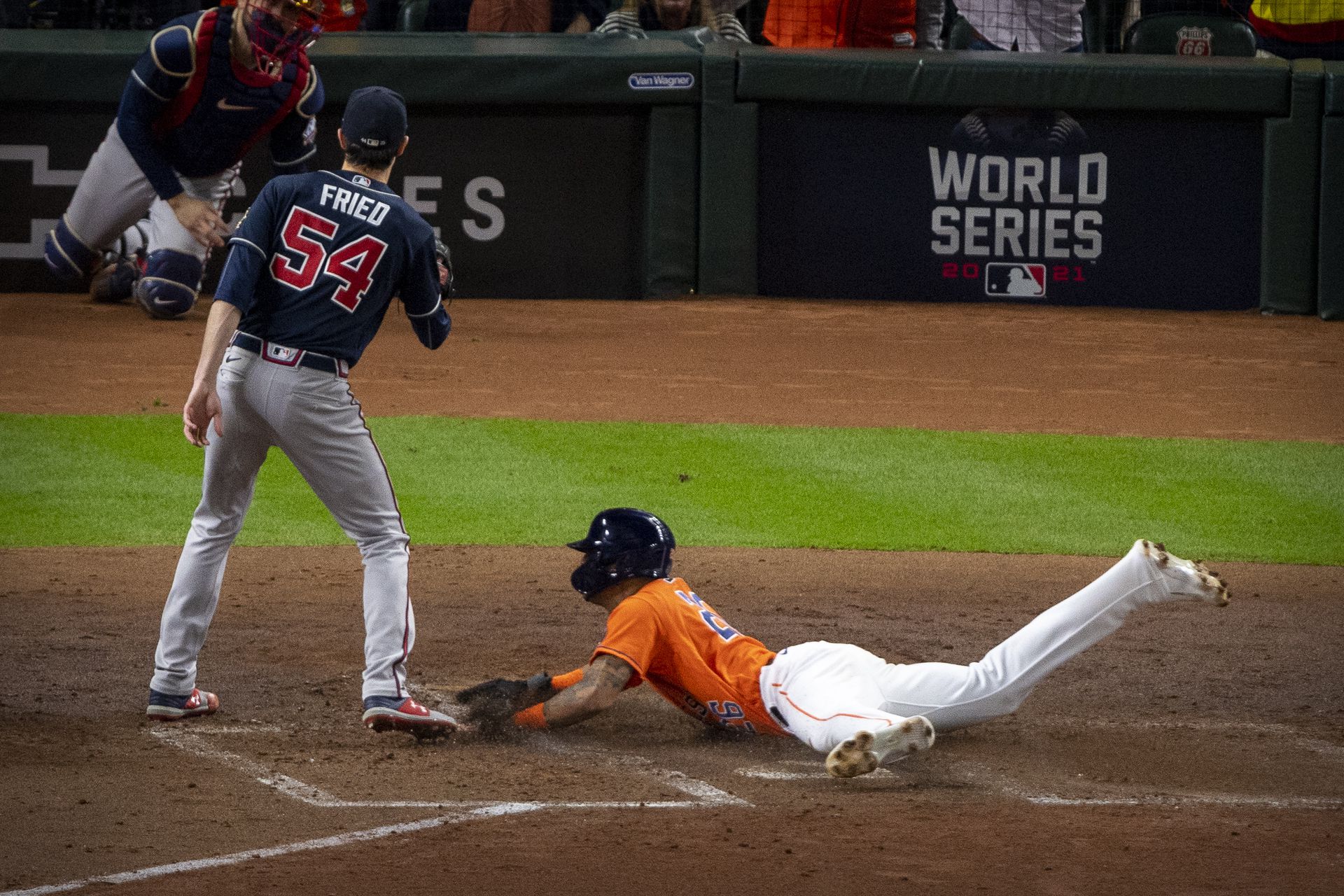 Houston Astros center fielder Jose Siri (26) slides past Atlanta Braves starting pitcher Max Fried (54) in the second inning during game two of the 2021 World Series at Minute Maid Park in Houston, Texas on Oct. 27, 2021.