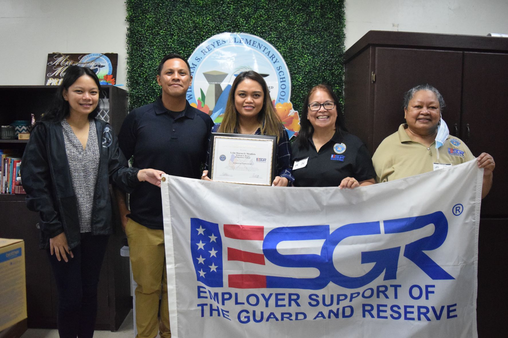 William S. Reyes Elementary School principal Lyn Sharon Mendiola, center, with vice principal Jocelyn Manibusan,  Spc. Roque Pulido, ESGR Guam-CNMI Area Chair Rita A. Sablan, Ed.D. and employer outreach coordinator Rose Igitol.