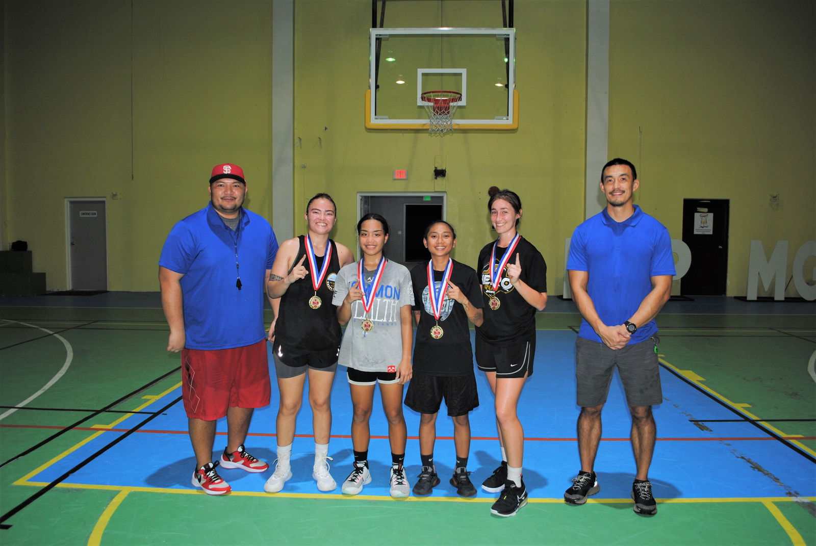 SHAMMI team members pose with their first-place medals and NMI Basketball Federation officials David John Apatang and James Lee.