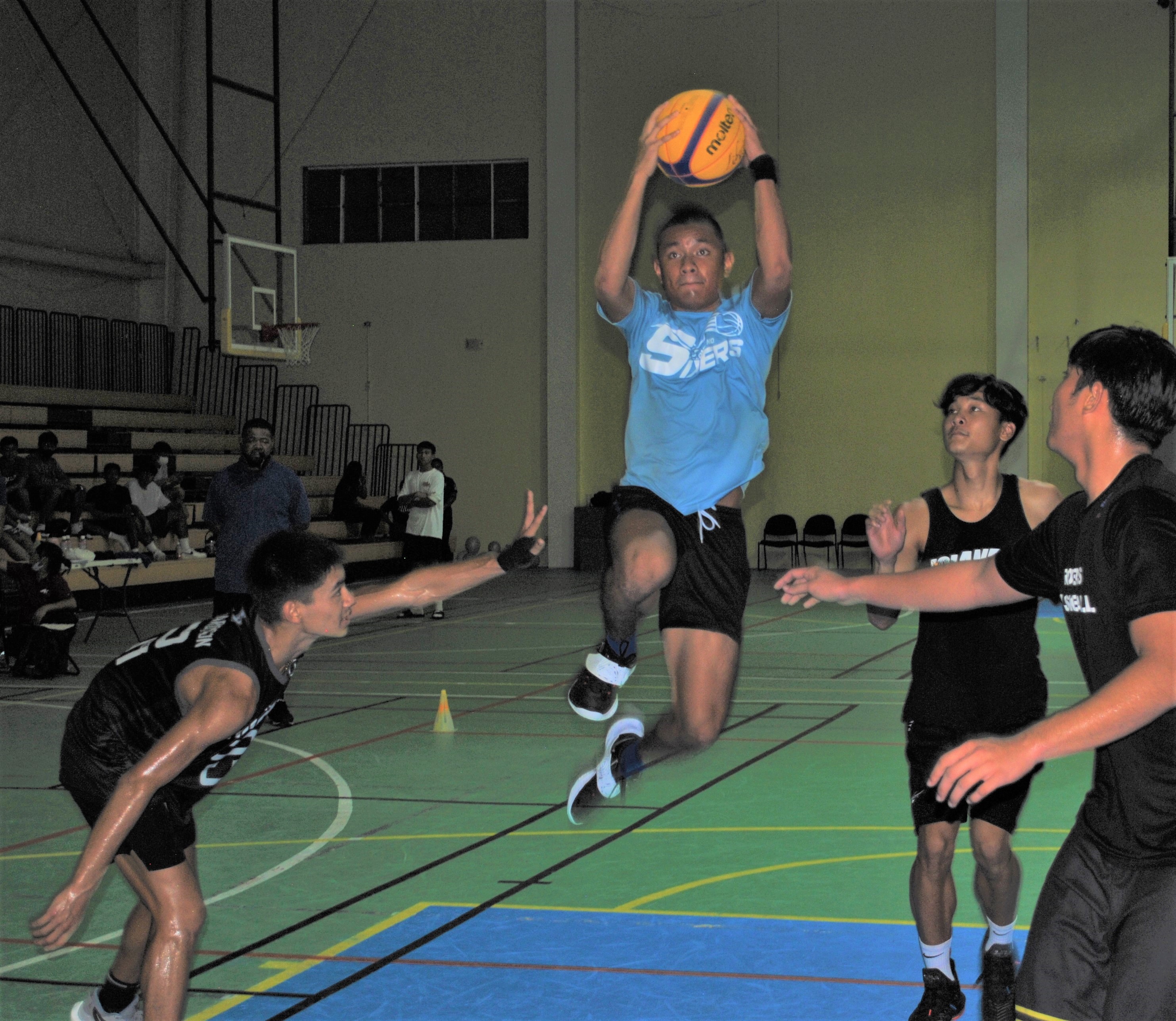 Babenome's Khristian Itaas protects the ball in midair as he executes the finish.