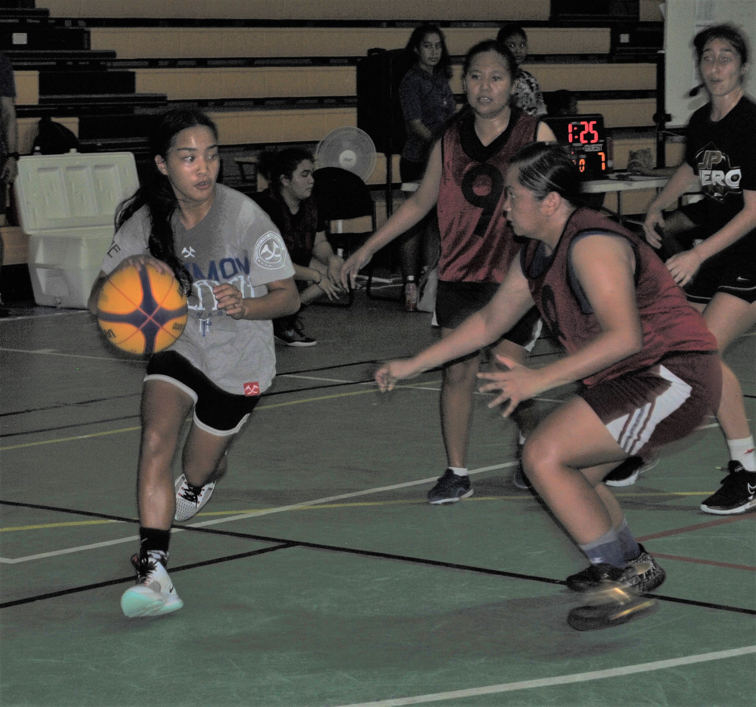SHAMMII's Shanesse Aldan dribbles past two defenders. 