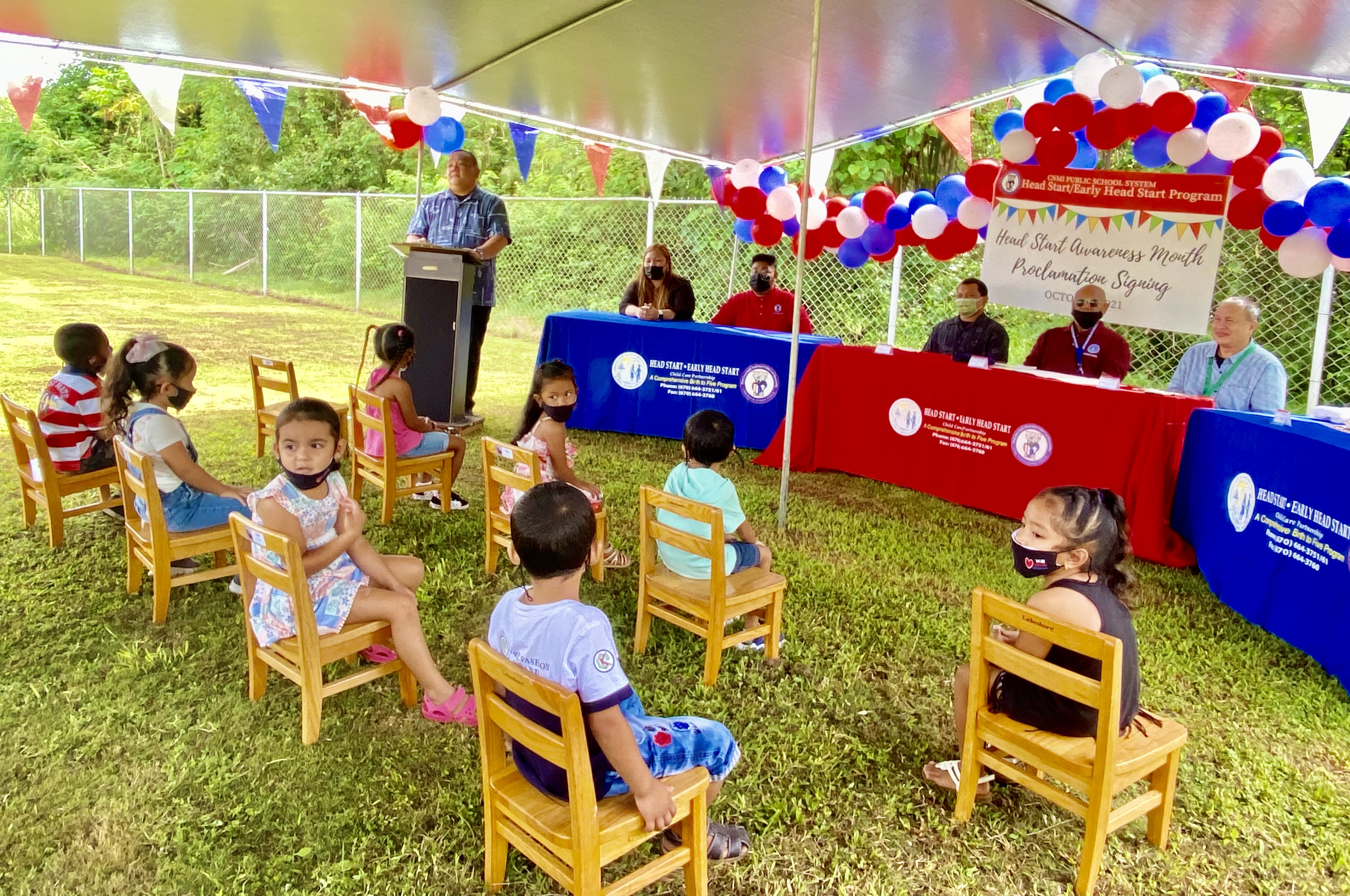 Acting Commissioner of Education Eric Magofna, left standing, speaks during the proclamation signing ceremony. Also in photo are Head Start children,  program director Lathania Santos, acting Rota Mayor Jonovan Lizama, Board of Education Vice Chairman Herman Atalig and BOE Chairman Andrew L. Orsini.
