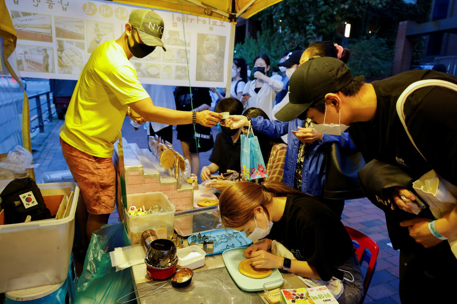 A street vendor sells Dalgona candy from the Korean Netflix series "Squid Game" at a Dalgona shop in Seoul, South Korea on Oct. 1, 2021. 