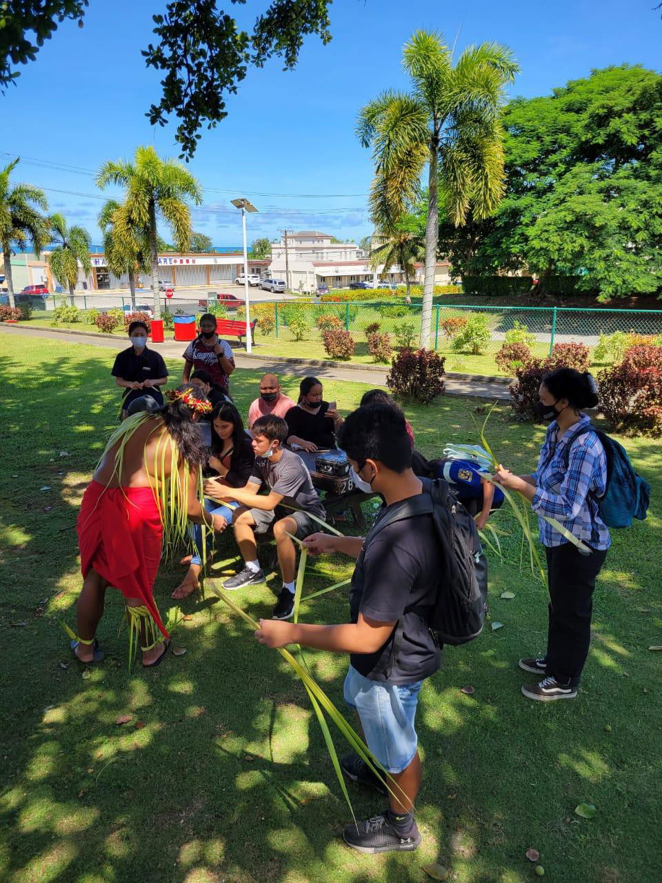 Troy Laniyo, left, demonstrates coconut frond weaving to students of Marianas Youth Welcome All Visitors Enthusiastically or MY WAVE Clubs of Kagman High School, Saipan Southern High School, and Marianas High School in Garapan, Saipan on Sept. 27, 2021, in celebration of World Tourism Day.