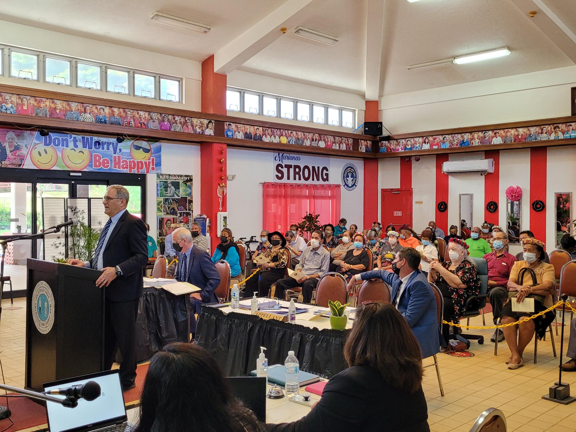 Attorney Richard Miller speaks before the appellate court at the Manamko’ Center. Behind him are attorneys Matthew Holley and Mark Scoggins and the senior citizens who observed the proceedings Tuesday.